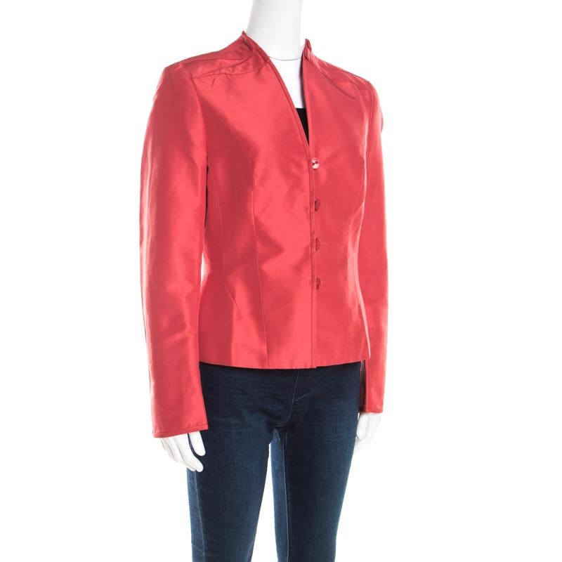 A classic silhouette in a refreshing orange hue, this blazer from Escada will make a worthy closet investment. It is tailored from quality silk and is styled well with button front closure, long sleeves and pleat details at the shoulder. Team this