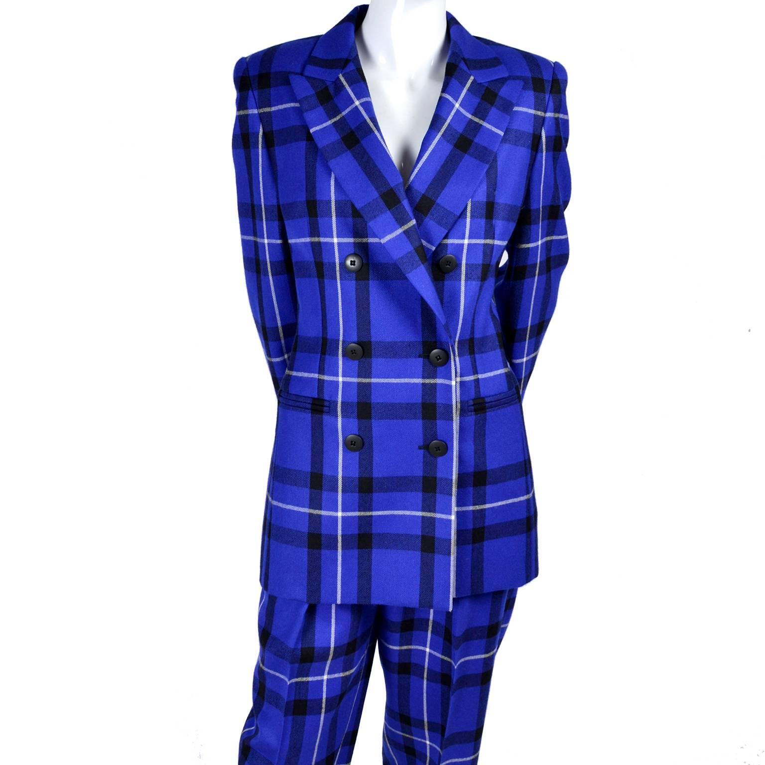 This vintage Escada pantsuit is perfectly on trend in a gorgeous blue plaid wool.  The suit was designed by Margaretha Ley and is 100% wool. The double breasted jacket is fully lined and has shoulder pads and front pockets.  The high waisted