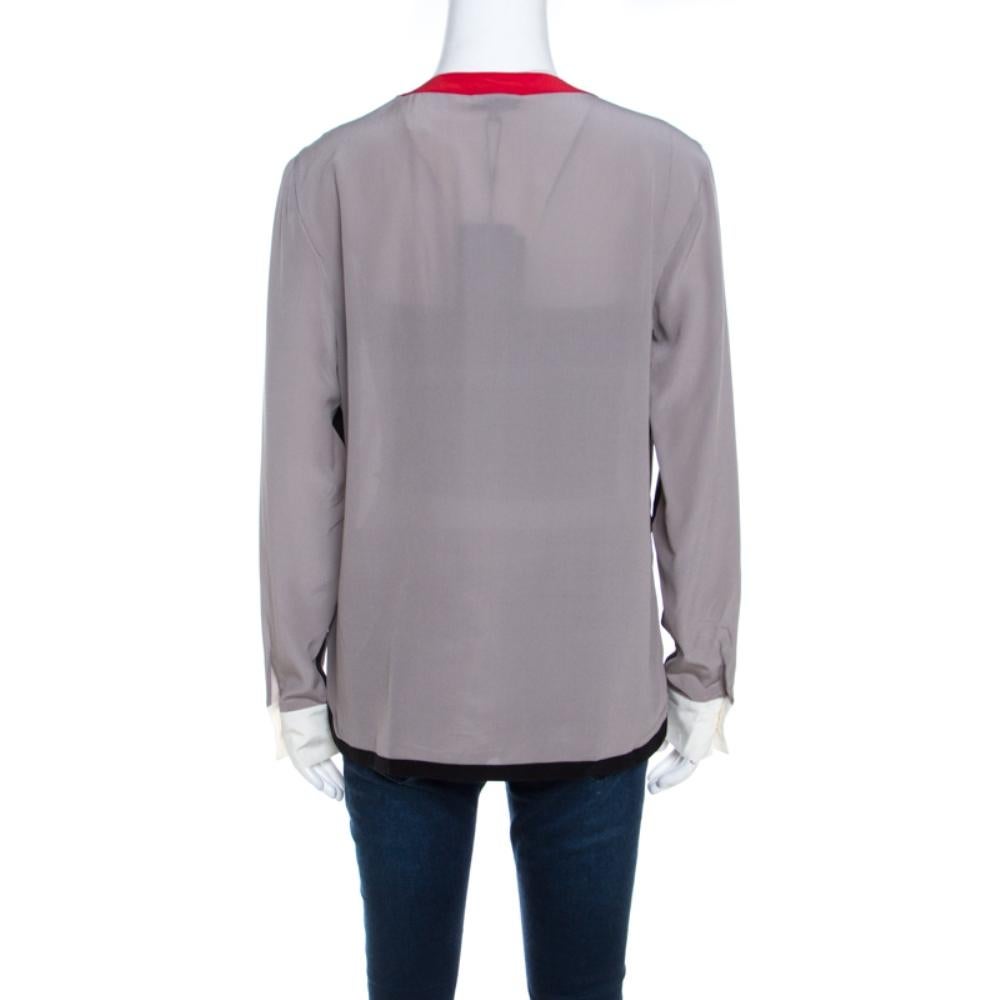 Give your formal wear a new look with this Escada creation. Tailored from smooth silk, this Nendi blouse features long sleeves and contrasting trim on the round neckline. With a button front closure, this piece offers a great fit.

Includes: The