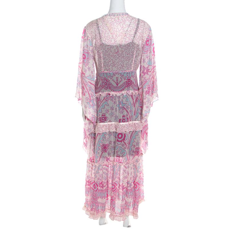 Escada's maxi dress is a holiday essential with its relaxing fit and breezy appeal. Accented with an abstract print all over, the dress gives the look of a tiered silhouette that lends it a fun, easy-going feel. It is complete with long sleeves and