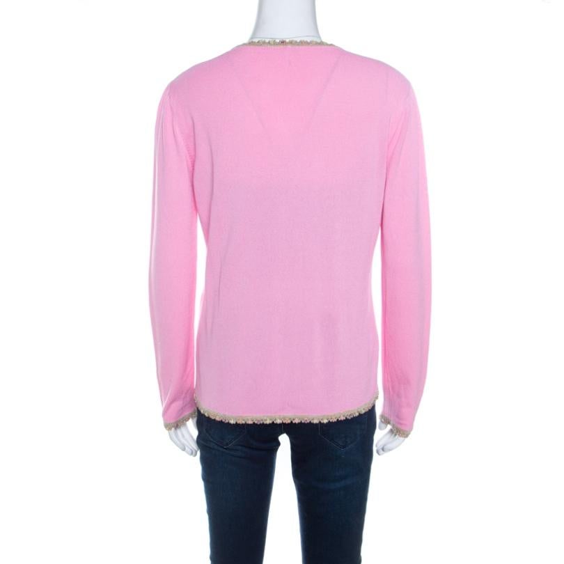 This Escada cardigan blends comfort and style perfectly! Lovely in pink, this cardigan is made of a cotton and rayon blend and features a V-neckline, front button fastening, long sleeves, and twin slip pockets. It comes with a beautiful sequined