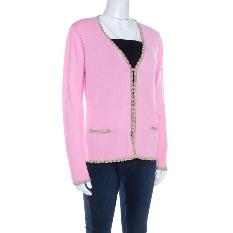 This Escada cardigan blends comfort and style perfectly! Lovely in pink, this cardigan is made of a cotton and rayon blend and features a V-neckline, front button fastening, long sleeves, and twin slip pockets. It comes with a beautiful sequined