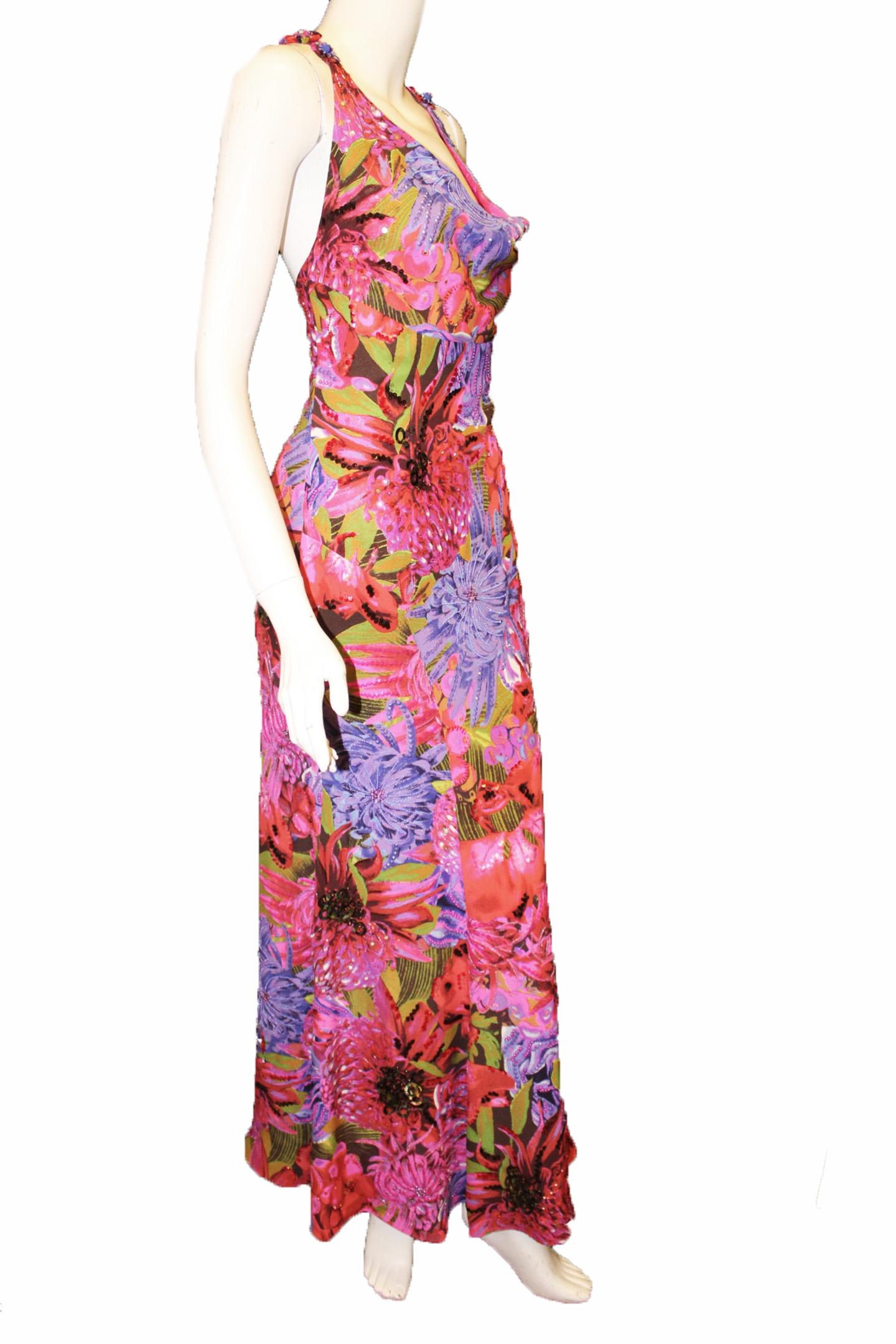 Escada pink multi color floral print dress highlighted with multi colored beads, crystals and sequins is true to the Escada workmanship.  The combination of all the different styles and sizes of beads and sequins is perfectly composed building on