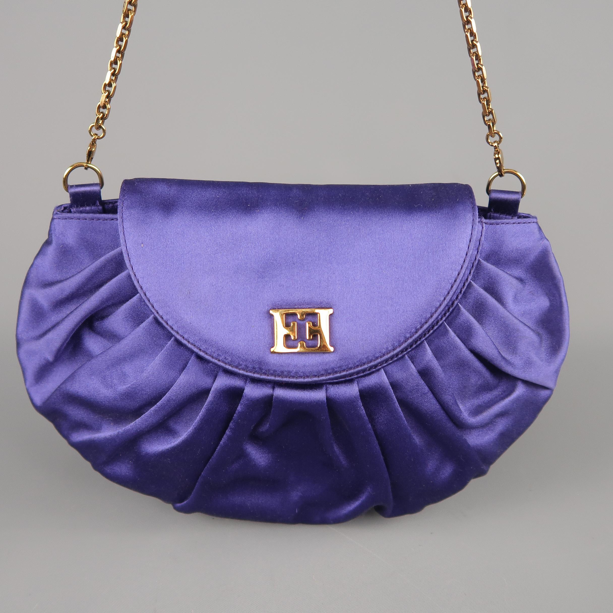 ESCADA evening bag comes in purple silk satin with a pleated body flap snap closure with gold tone metal EE logo and detachable chain strap. Wear on interior. Made in Italy.
 
Good Pre-Owned Condition.
 
Measurements:
 
Length: 9.5 in.
Width: 1.5
