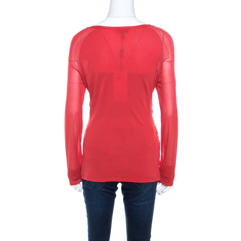 You must get your hands on this lovely creation from Escada. The red top is sewn perfectly and it has long sheer sleeves and a crossover front. It can be teamed with jeans or trousers and a pair of glossy pumps.

Includes: The Luxury Closet