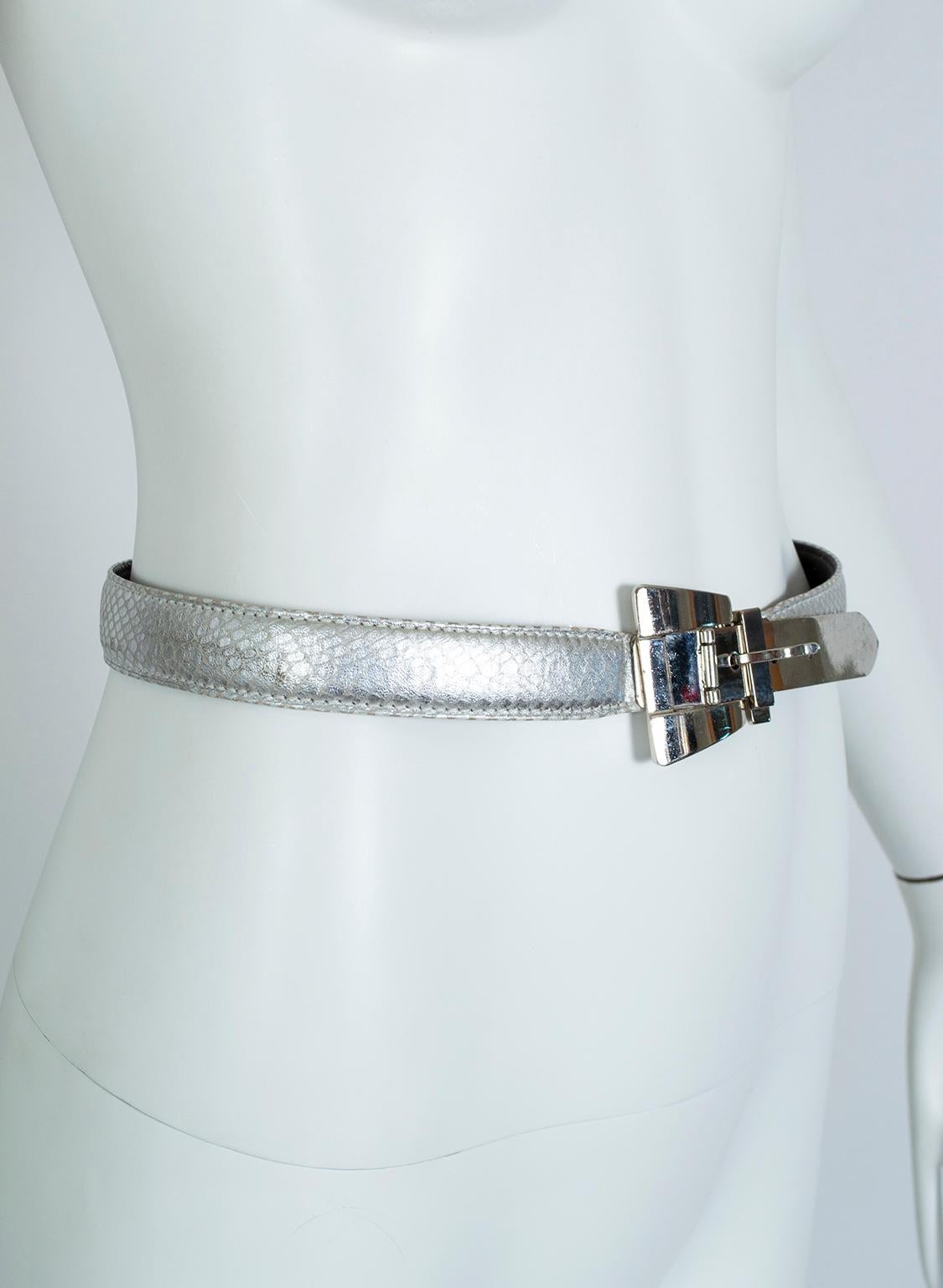 Silver leather belts are a modern neutral that--when paired with silver shoes--can make a monochrome outfit sing. This Escada model takes the idea a step further with snakeskin embossing and a unique Modernist buckle design whose metal tail fishes