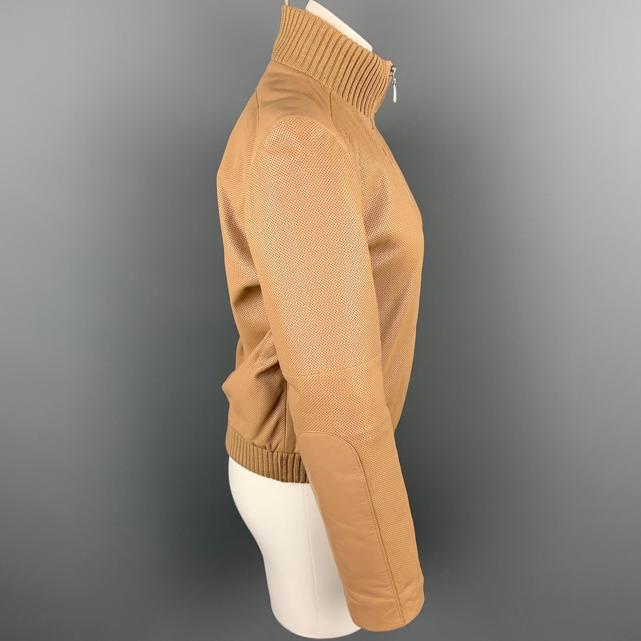 ESCADA jacket comes in a beige perforated leather with a quilted liner featuring a bomber style, wool sleeves, slit pockets, and a zip up closure.
Very Good
Pre-Owned Condition. 

Marked:   34 

Measurements: 
 
Shoulder: 16 inches  Bust: 36 inches 