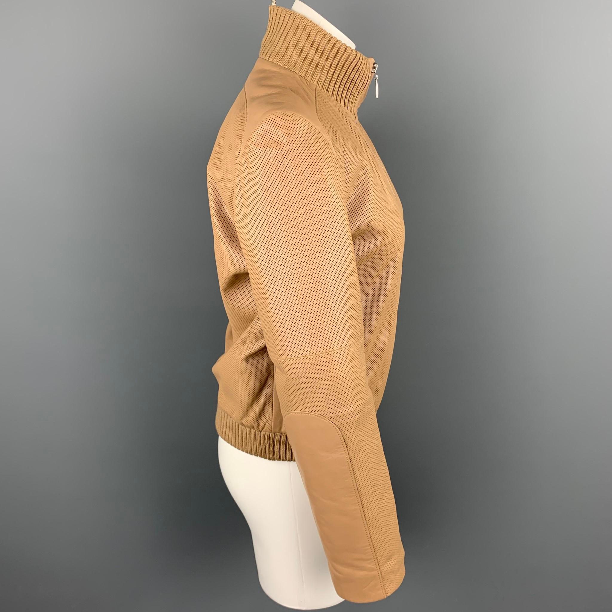 ESCADA jacket comes in a beige perforated leather with a quilted liner featuring a bomber style, wool sleeves, slit pockets, and a zip up closure. 

Very Good Pre-Owned Condition.
Marked: 34

Measurements:

Shoulder: 16 in.
Bust: 36 in.
Sleeve: 25