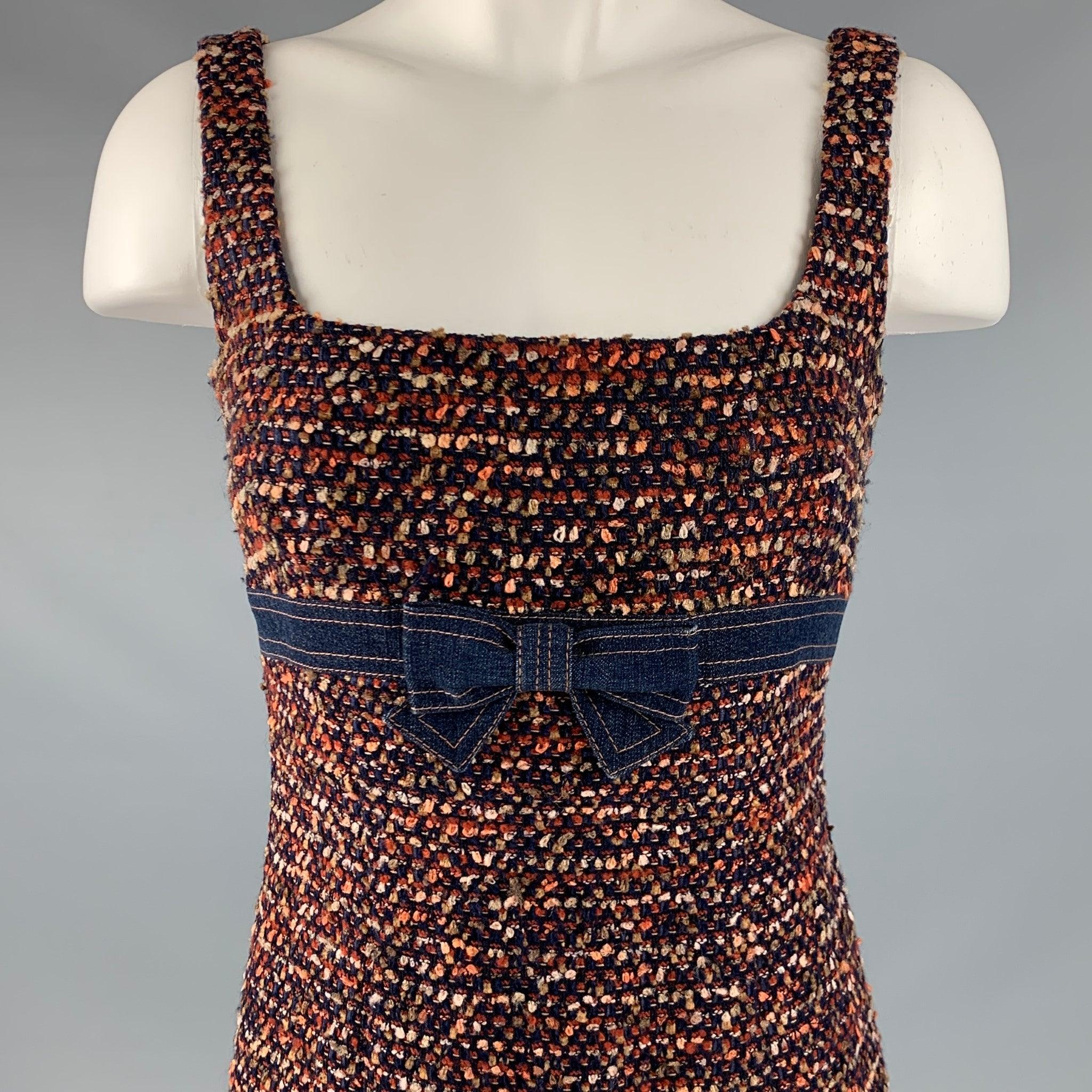 ESCADA dress
in a navy and rust orange wool blend boucle fabric featuring a sleeveless style, knee length, and empire waist with denim bow trim.Excellent Pre-Owned Condition. 

Marked:   34 

Measurements: 
 
Shoulder: 14.5 inches Bust: 30 inches