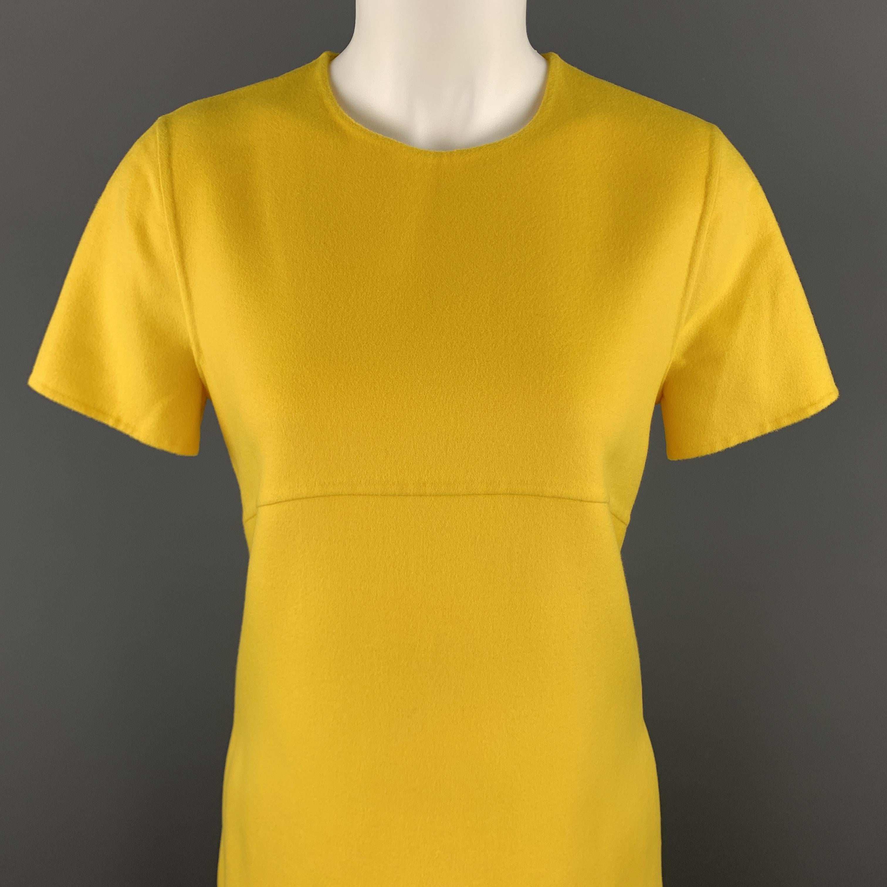 ESCADA A line shift dress comes in Mirabelle yellow wool cashmere blend flannel with a round neckline, short sleeves, and slit side pockets. 

New with Tags.
Marked: DE 36

Measurements:

Shoulder: 15 in.
Bust: 36 in.
Waist: 34 in.
Hip: 42
