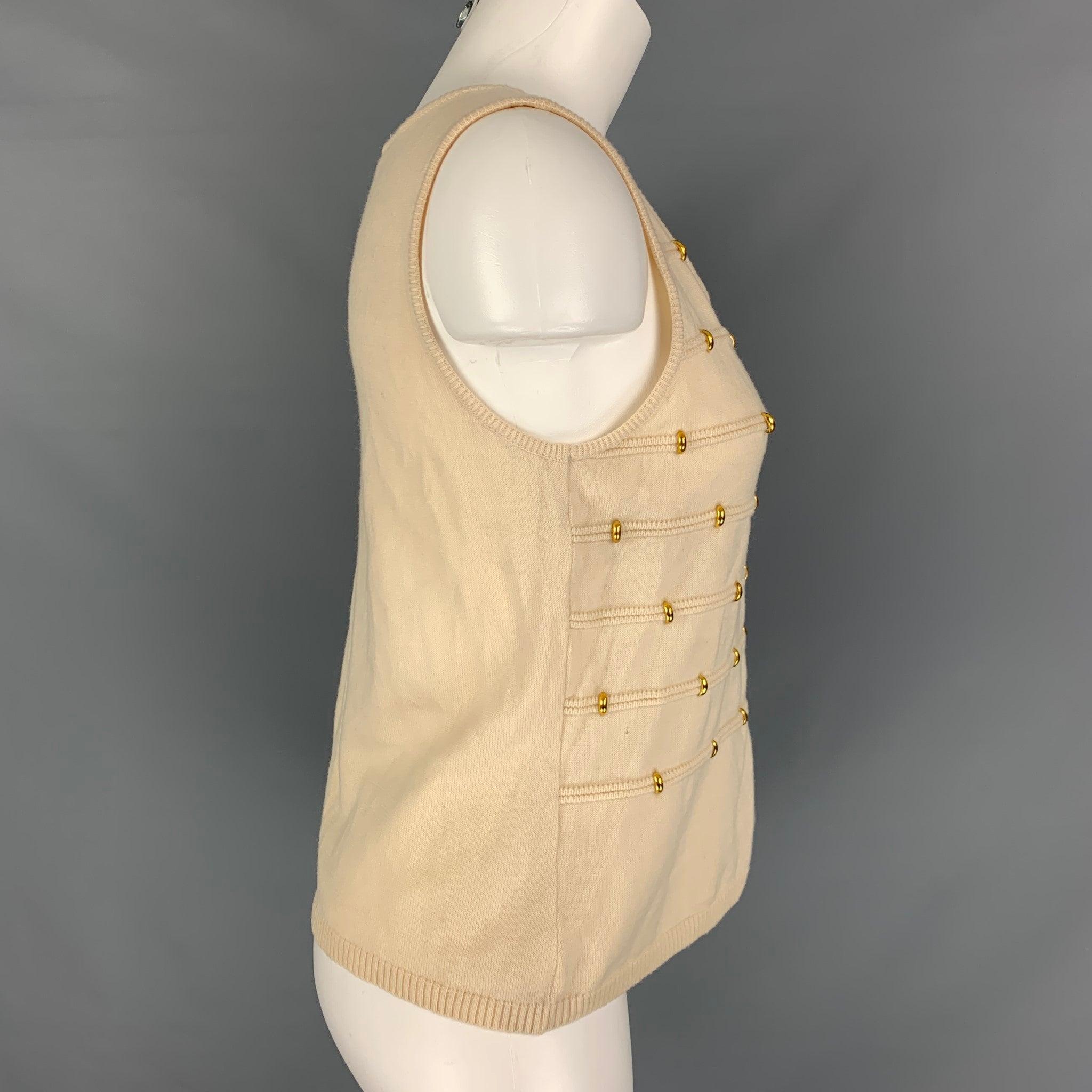 ESCADA sleeveless dress top comes in cream wool knit jersey featuring gold tone embellished and crew neck. Made in Germany.Very Good Pre-Owned Condition. 

Marked:   38 

Measurements: 
 
Shoulder: 13 inches  Bust: 34 inches  Length: 20 inches 
  
 