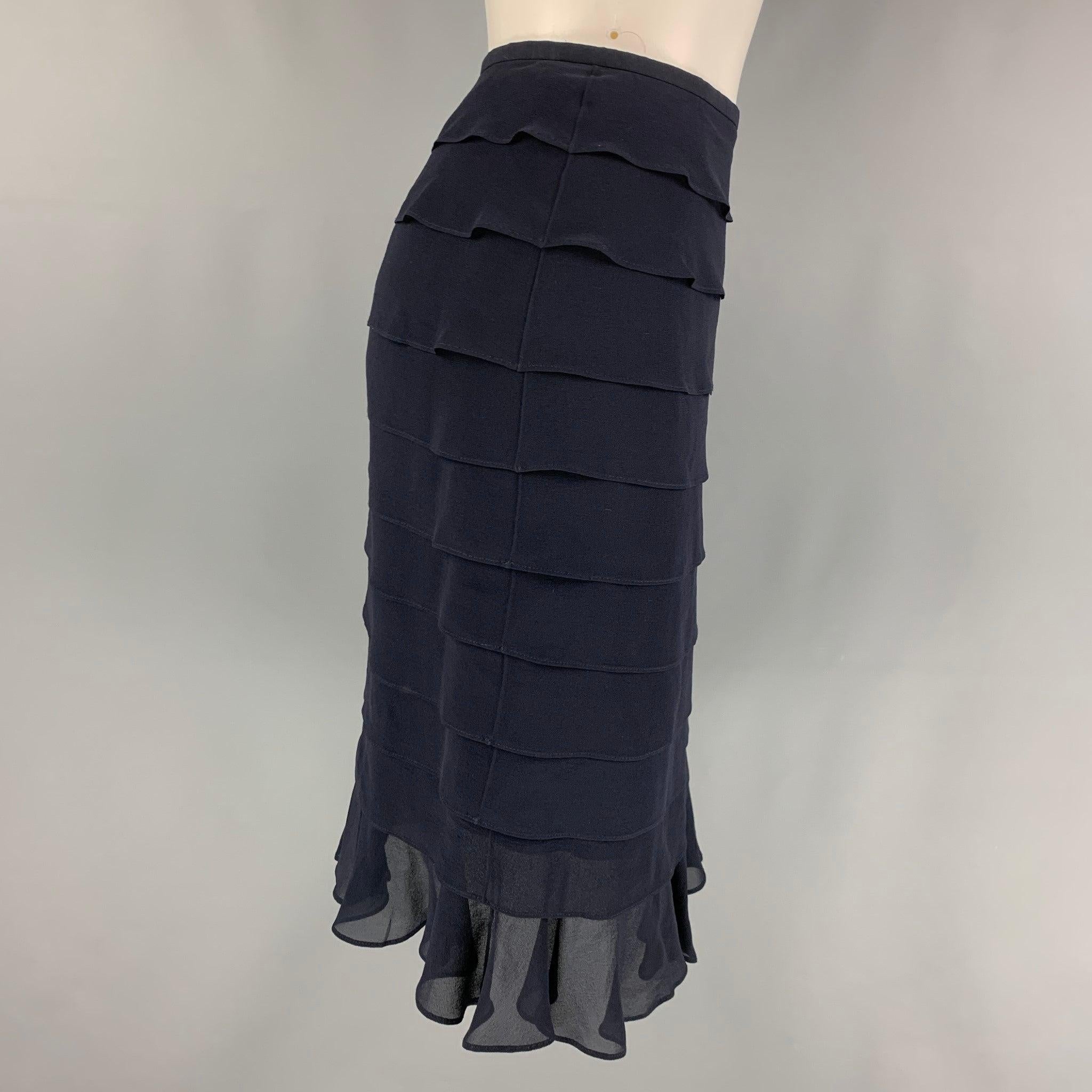 ESCADA skirt comes in a navy layered silk featuring a ruffled style and a side zipper closure.
Very Good
Pre-Owned Condition. 

Marked:   38 

Measurements: 
  Waist: 28 inches  Hip: 36 inches  Length: 23 inches 
  
  
 
Reference: 118318
Category: