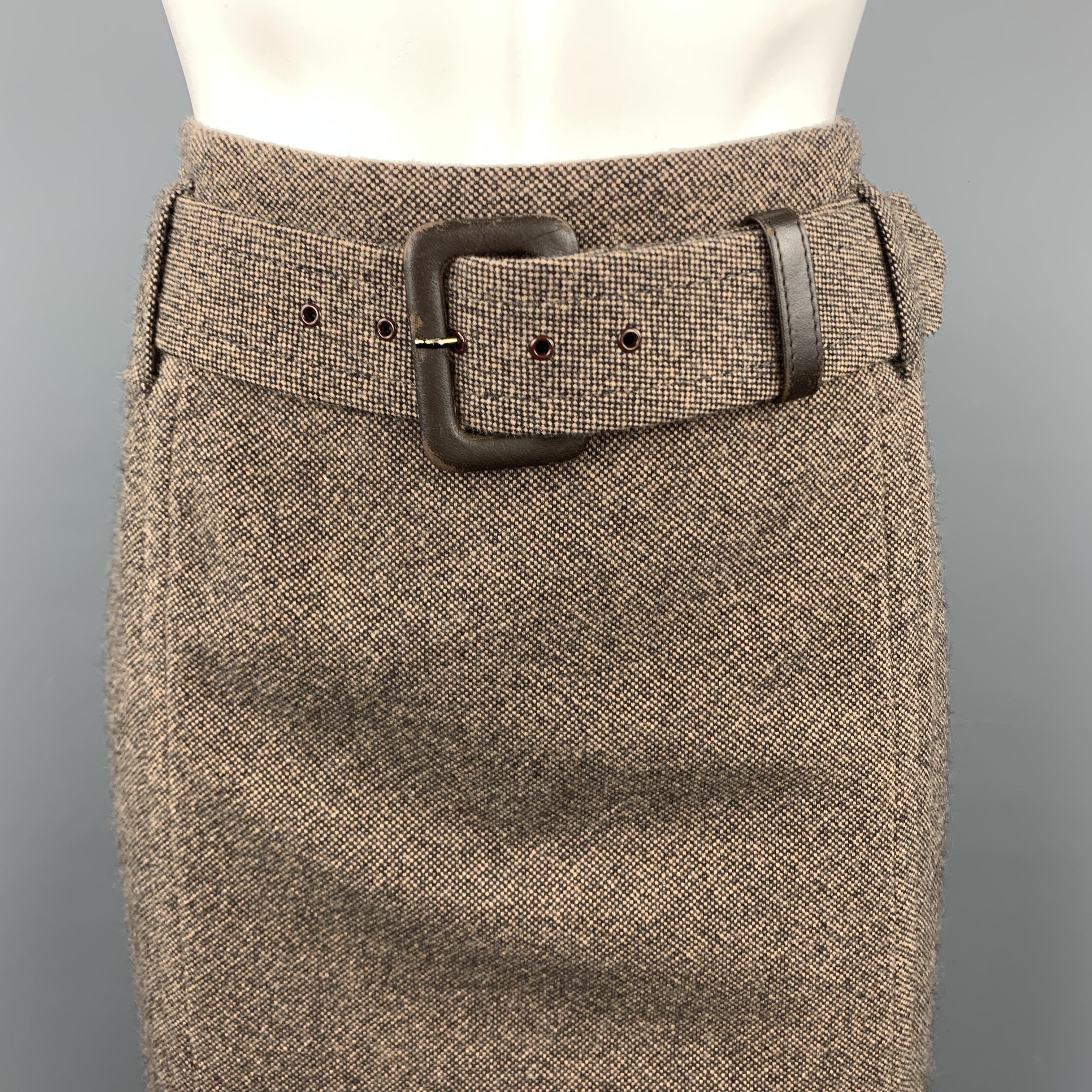 ESCADA skirt comes in brown and beige woven tweed with a matching fabric belt with brown leather buckle. Wear on buckle. As-is. 

Good Pre-Owned Condition.
Marked: IT 38

Measurements:

Waist: 30 in.
Hip: 40 in.
Length: 23 in.