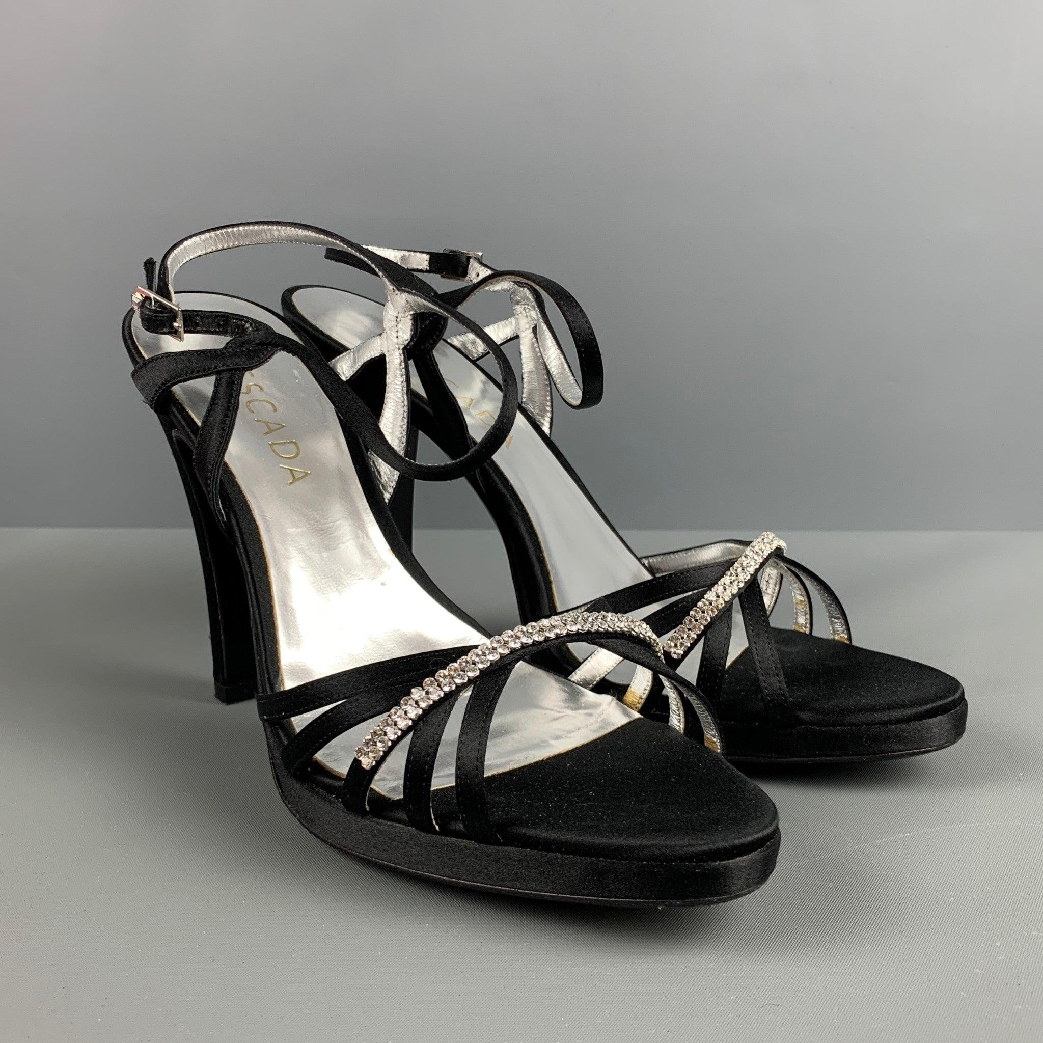 ESCADA sandals comes in a black silk material featuring an ankle strap, and silver rhinestones detail. Comes with the box and dust bag. Made in Italy.Very Good Pre-Owned Condition. Minor signs of wear. 

Marked:   39 

Measurements: 
  Heel: 4.5