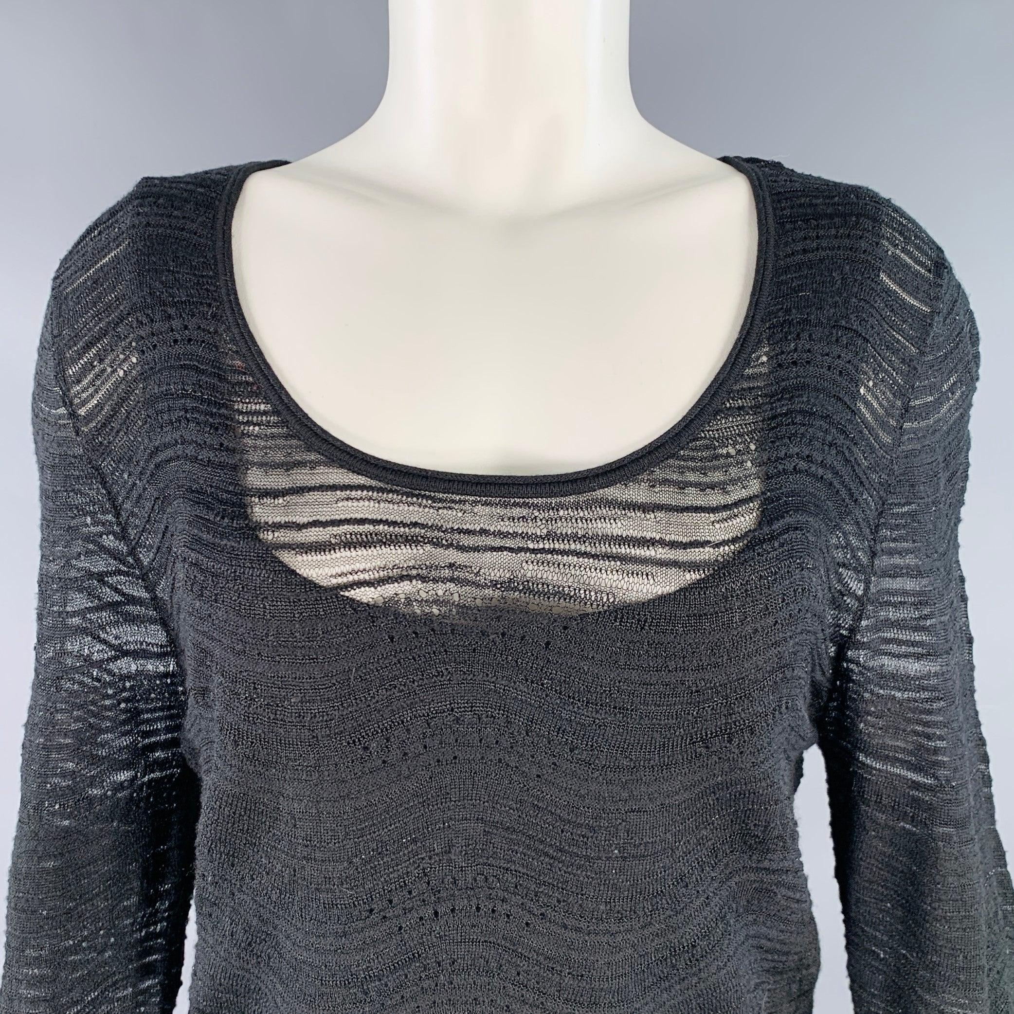 ESCADA pullover
in a wool blend knit featuring a textured stripe pattern, long sleeves, and scoop neck. Comes with attached tank top.Good Pre-Owned Condition. Moderate snags. 

Marked:   M 

Measurements: 
 
Shoulder: 16.5 inches Bust: 35 inches