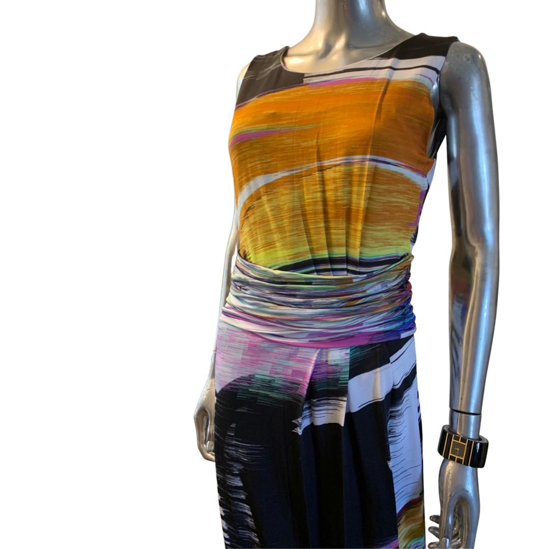 What a chic city dress from Escada. A sleeveless sheath in the most amazing and colorful abstract print. The dress is draped in the side front bodice and skirt and wrapped in a ruched belt at the waist. So flattering on! Made in Turkey. European