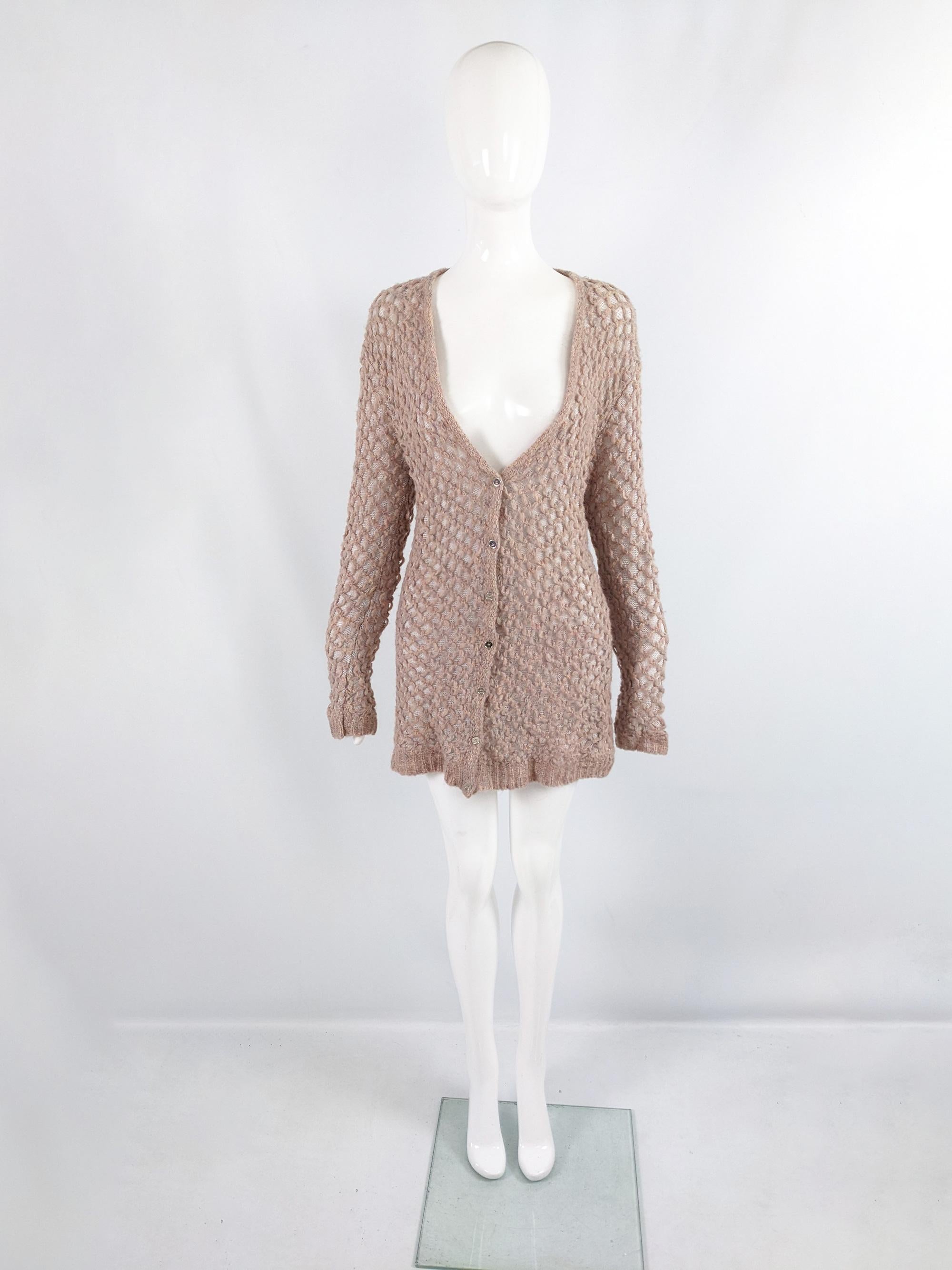 A beautiful vintage womens cardigan from the early 2000s by luxury fashion house, Escada. In a pastel pink soft, fuzzy knit with multicolored flecks throughout and a lattice design overlaid on a sheer knit lining. It has a longer length and 'Escada'