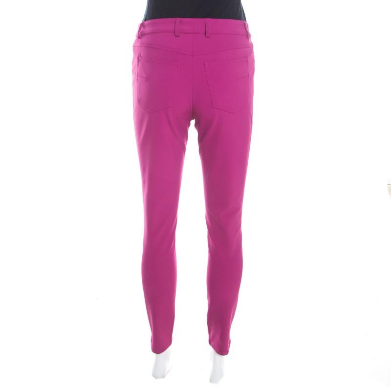 These pink tailored trousers from Escada will make you look smart and stylish without compromising on comfort. They are made of a blend of fabrics and will lend you a great fit. Pair them with chic sweaters and flat loafers to make a casual style