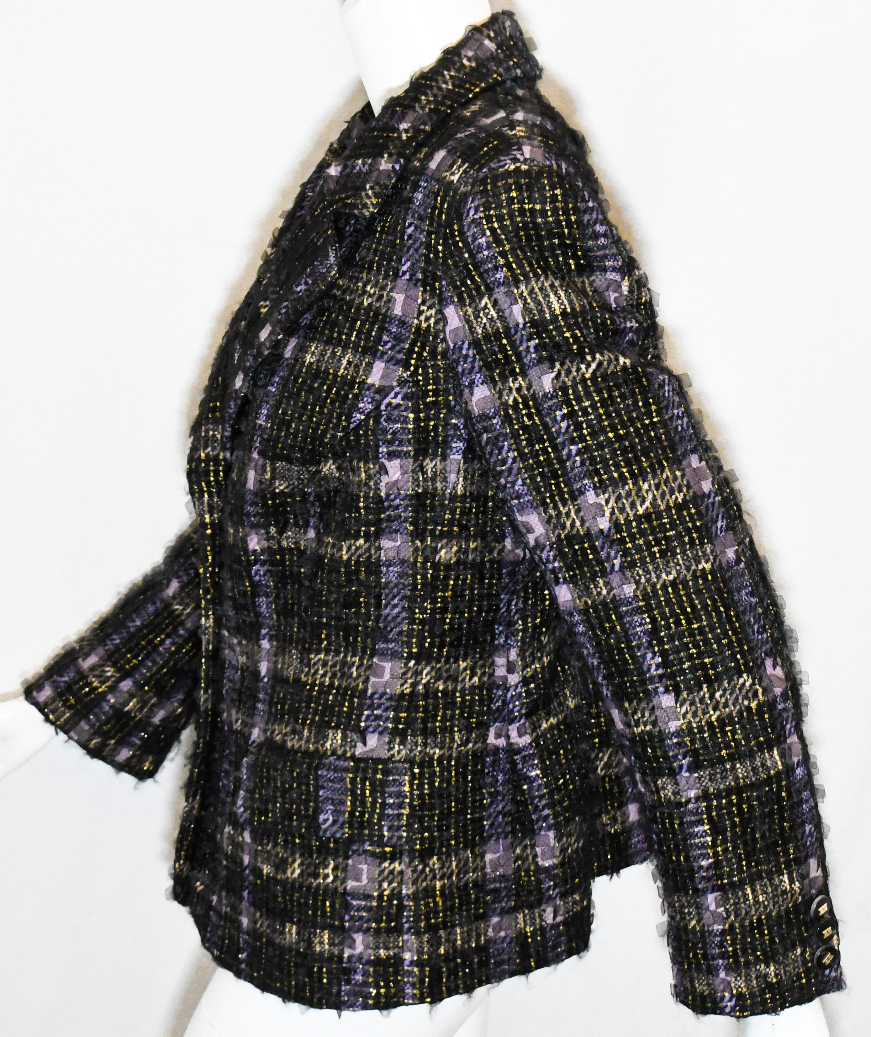 Escada tweed jacket in a check design decorated with gold tone, black and purple threads throughout.  This jacket is accentuated with silk organza sequin like details allover.  The jacket is lined in black cupro.  With a notch collar, two front flap