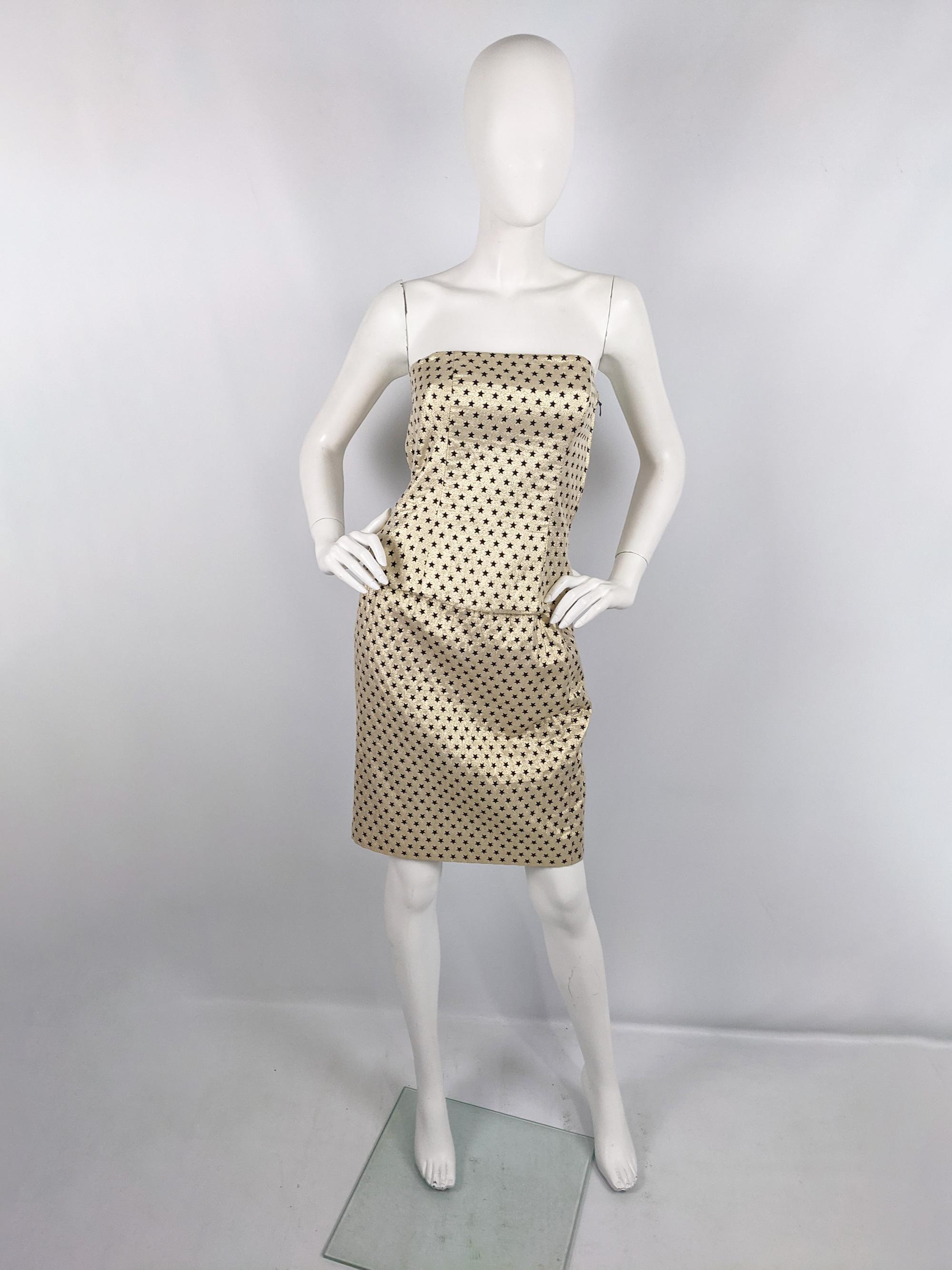 A fabulous and rare vintage Escada two piece set from the early 90s by luxury fashion house, Escada. In a metallic gold cotton and lamé fabric with a black star pattern woven throughout. Consisting of a strapless, boned bodice top and a matching