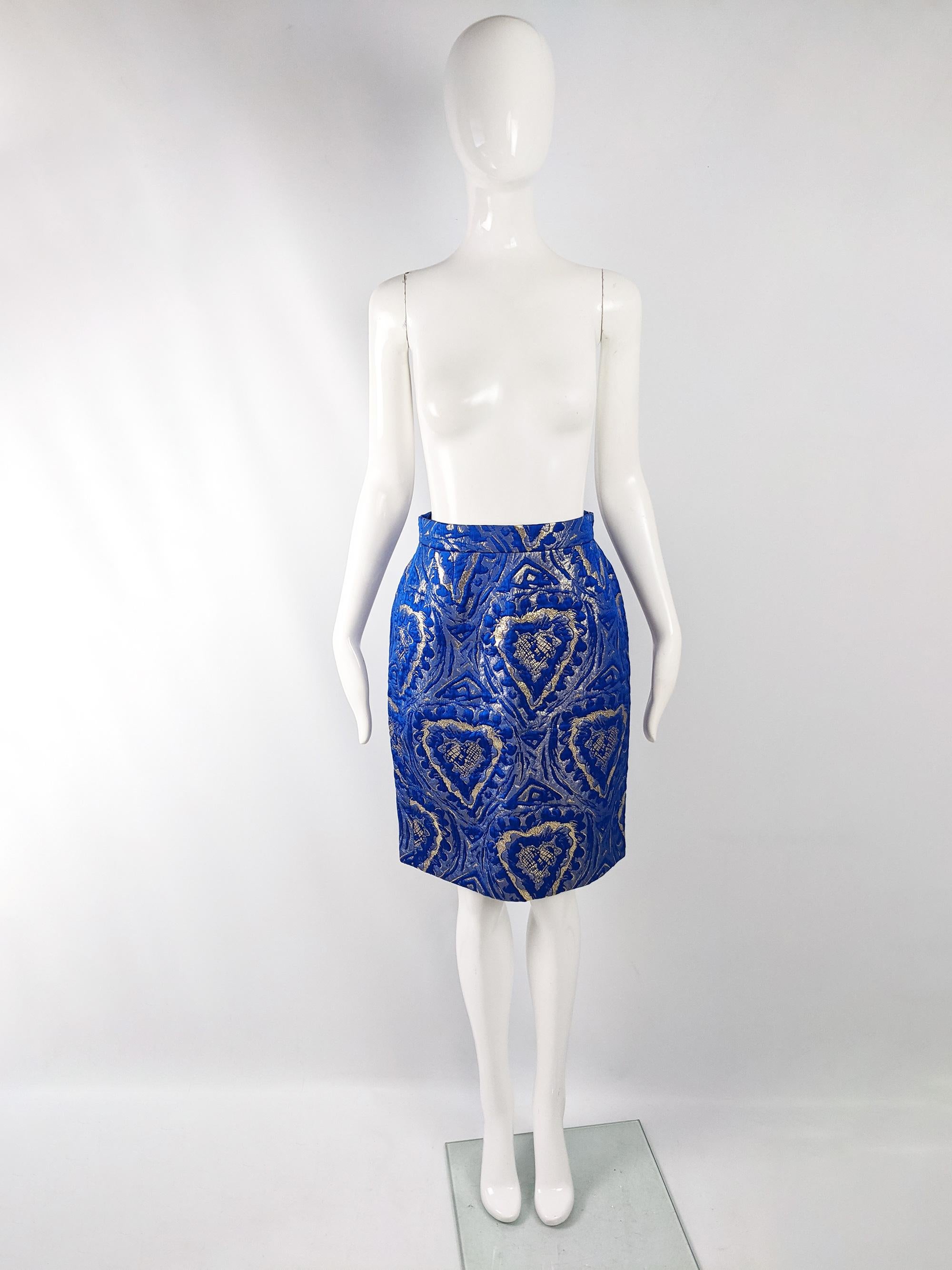 A luxurious vintage Escada skirt from the 80s in a thick blue wool and silk fabric with a gold love heart brocade throughout. Perfect for a glamorous look at a party or evening event. 

Size:  Marked vintage 38 but measures like a modern UK 8-10/ US