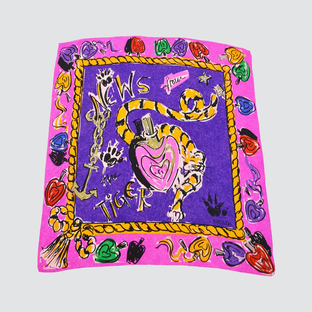 Size: Width  - 31” / 79cm x Length - 33” / 84cm

A stunning vintage women's scarf from the 80s by luxury German fashion house, Escada. In a pure silk with a bold tiger image wrapped around a heart shaped perfume bottle with a gold painted lid and
