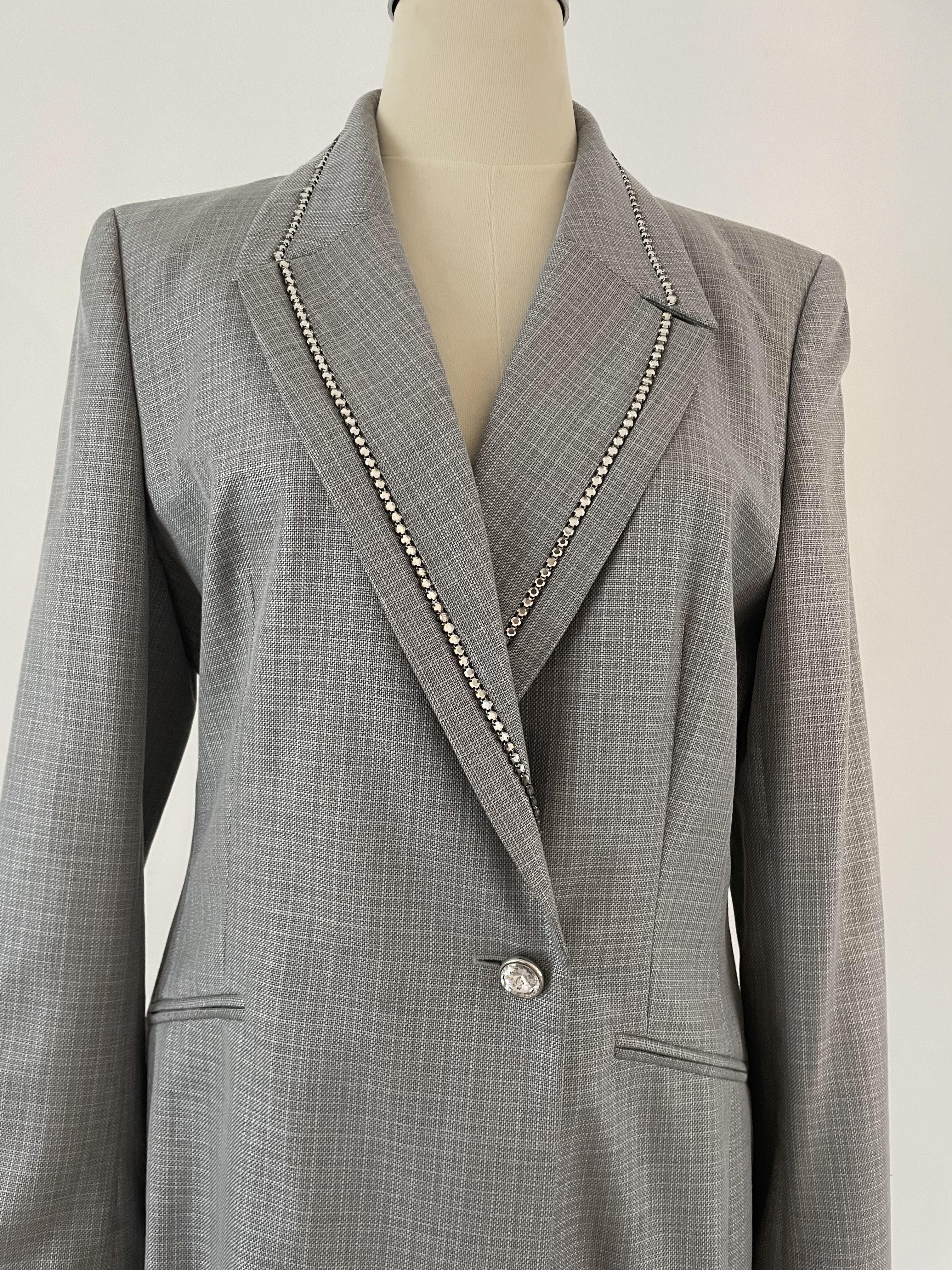 This beautiful, timeless and still fashionable Escada1990s suit including trousers (with a row of rhinestones at the sides) and a skirt, is iconic for its luxurious, bold style that embodies the power and glamour of the decade. Made of wool and