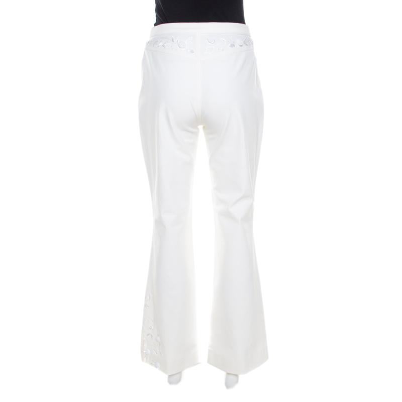 Every wardrobe deserves a fabulous pair of jeans and what better than these jeans from Escada. The white pair is made of a cotton blend and features a lovely sequined rosette applique on the front. Flared bottoms and front and back pockets all make