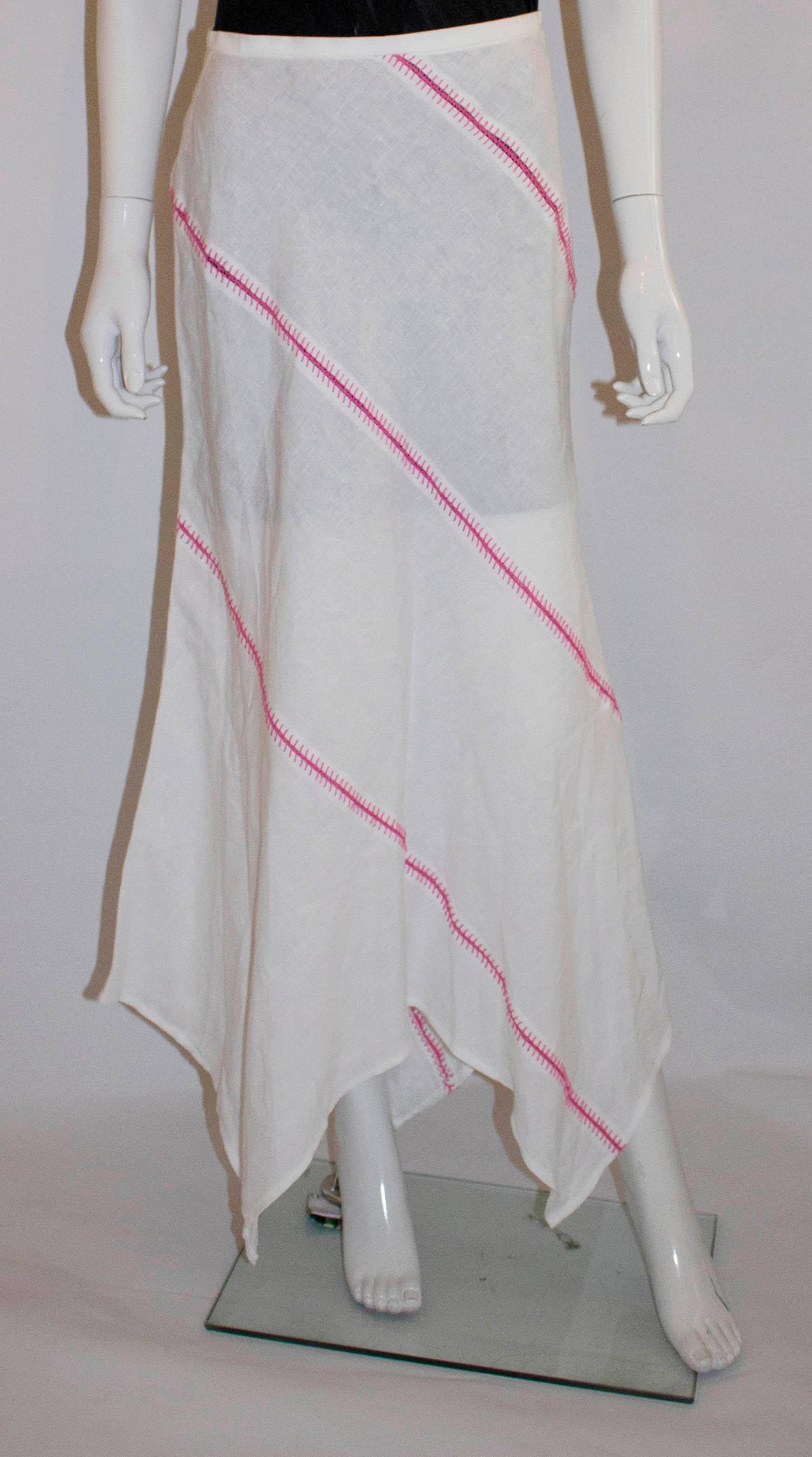 A fun skirt for Summer by Escada. In white linen with pink stitch detail, the skirt has an asymetreic hem and zip opening. Size 36 , waist 26'',length 41''