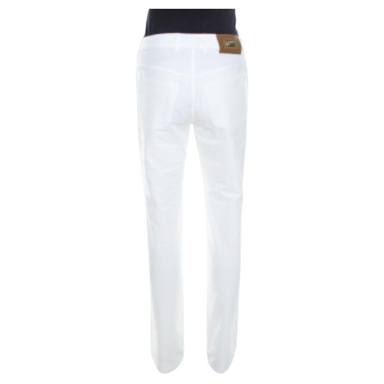 Realizzati in misto cotone, questi jeans a vita alta sono firmati Escada. Questa creazione è elastica e offre un'ottima vestibilità. Questi jeans Tessa presentano cinque tasche esterne e una chiusura a zip. Questo capo bianco a gamba dritta esalterà