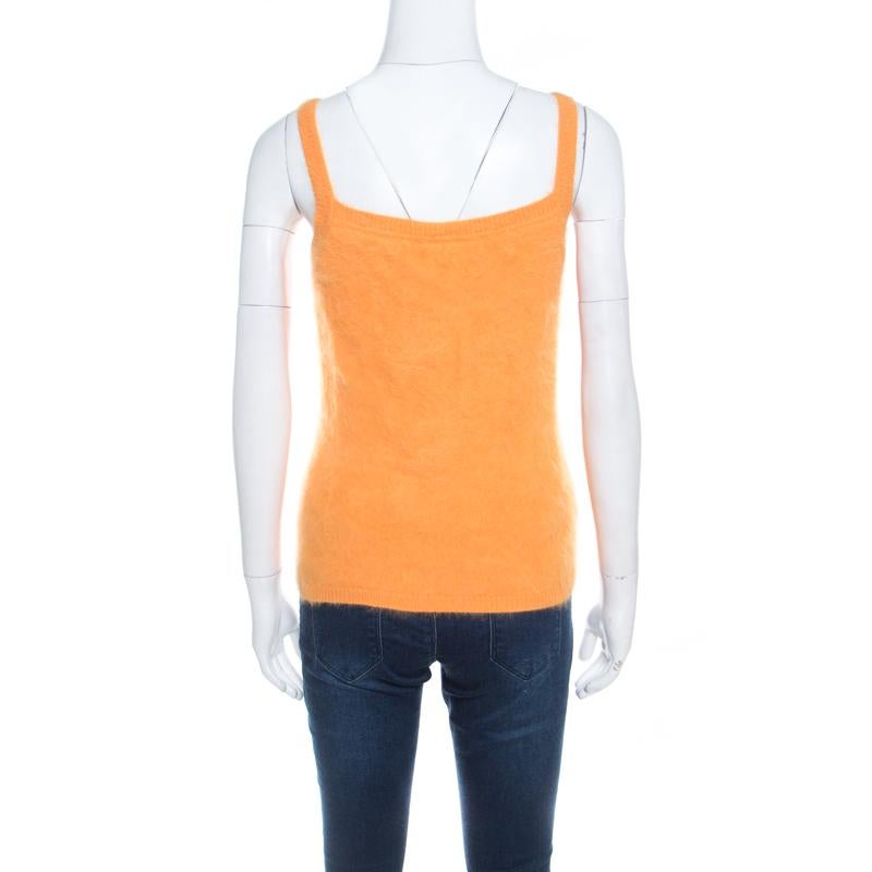 For days of luxurious warmth, Escada brings you this fuzzy tank top that has been made from an angora blend and lined with silk. The yellow top is soft as well as plush, and can be worn under cardigans or coats.

Includes: The Luxury Closet