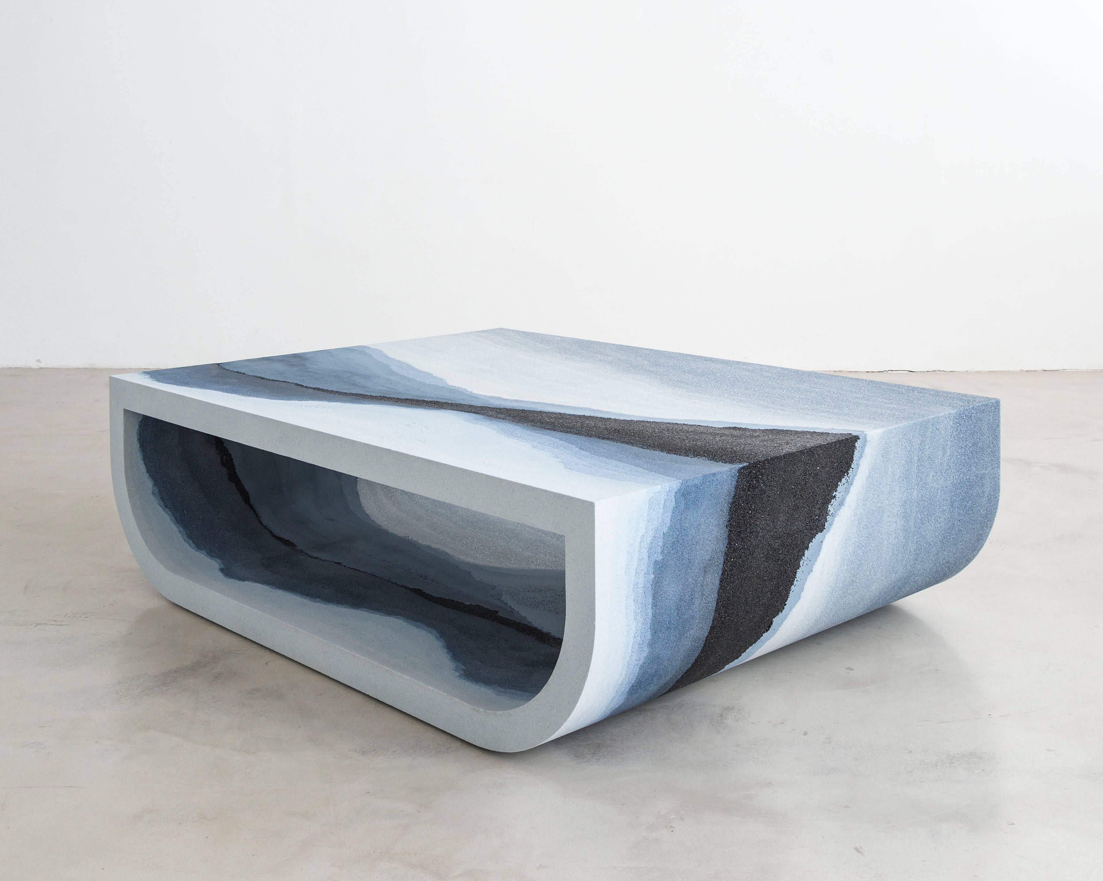 A layering of glass, sand, and silica, the made-to-order coffee table consists of gradients of tones and textures suggesting layers of earth, mountain ranges, otherworldly skies and bodies of water. The hand-dyed granules are stratified with