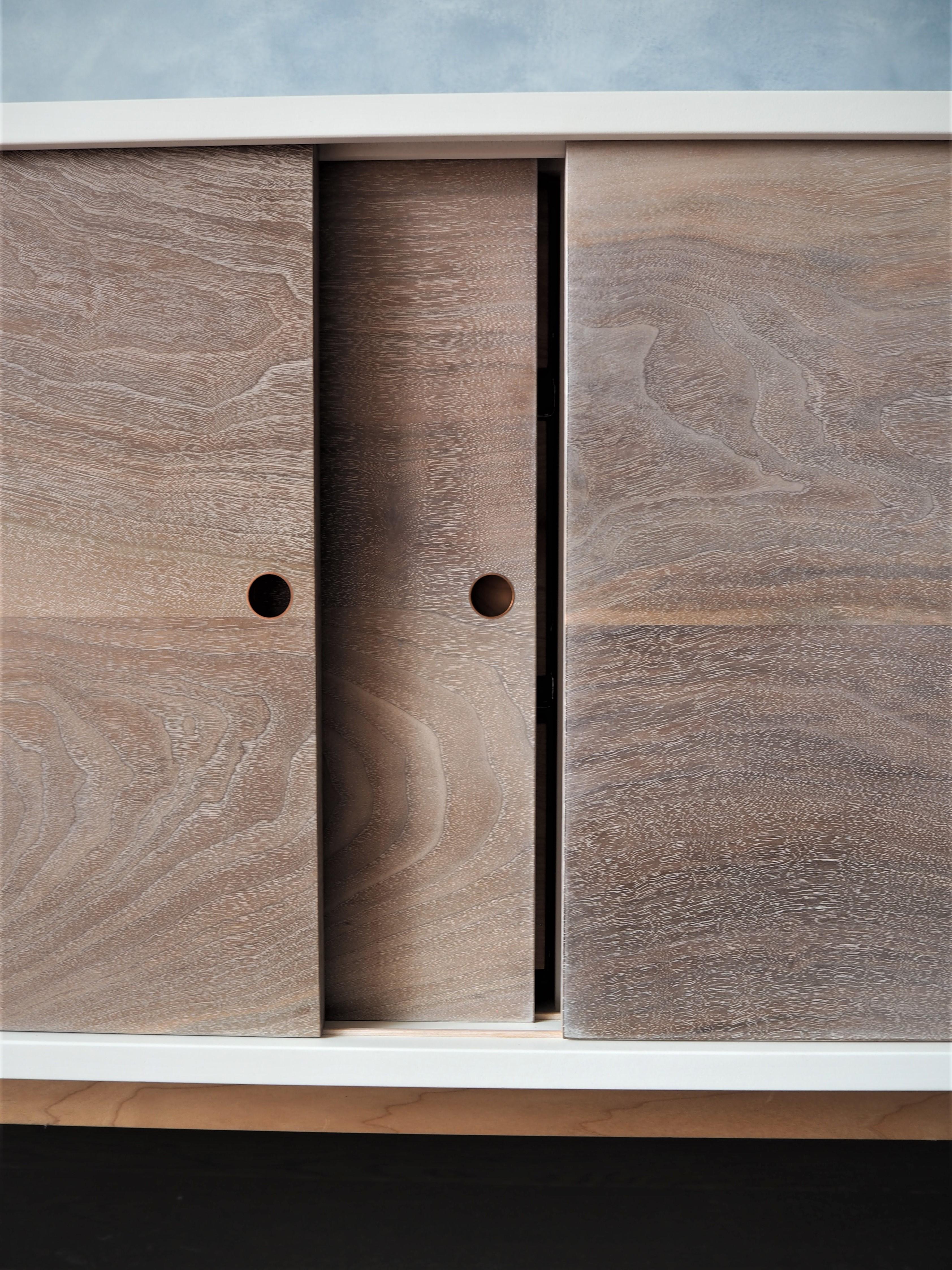 White Sideboard with Sliding walnut Doors and a solid maple base by MSJ Studio 3