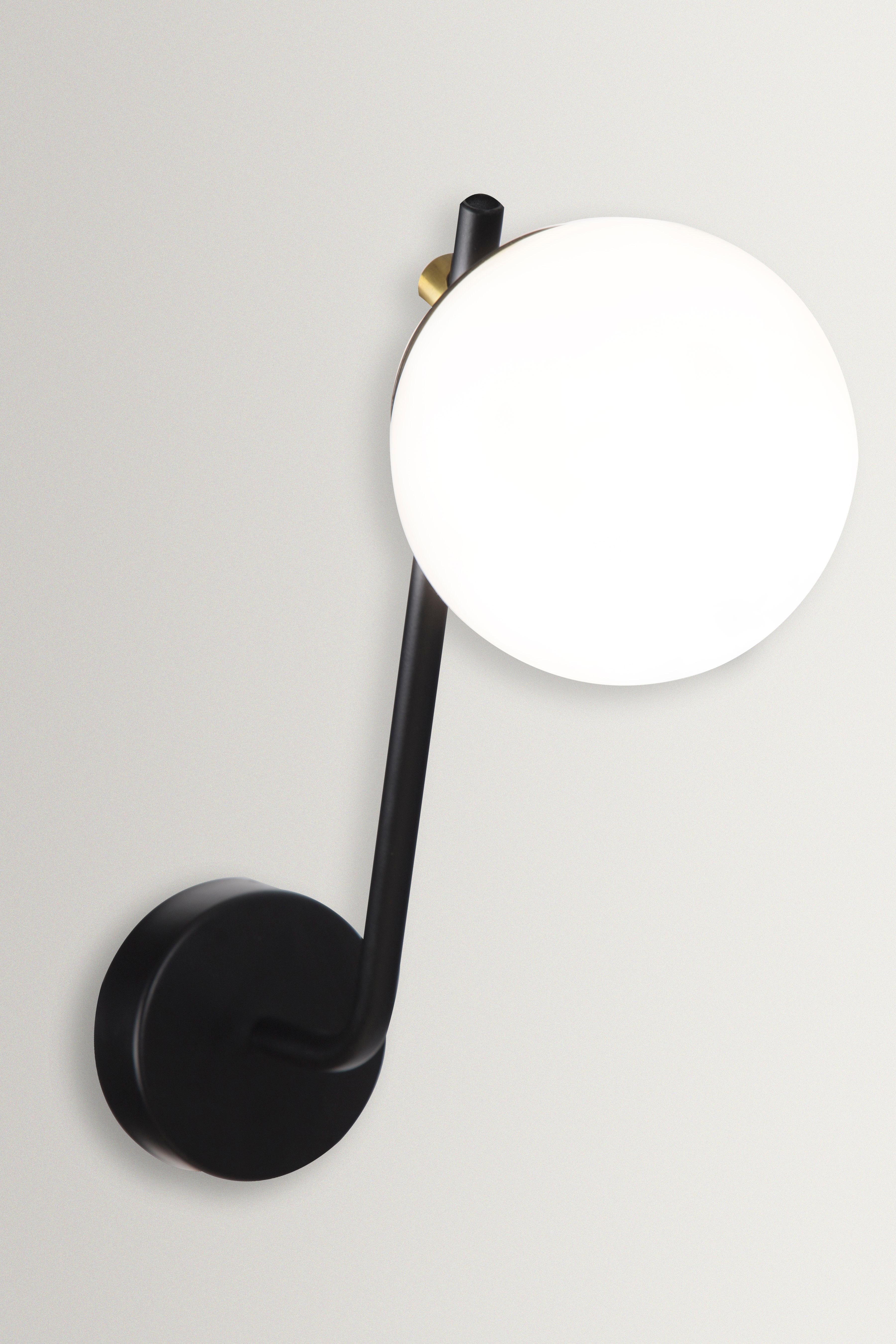 Esferra 120 wall lamp by Hatsu
Dimensions: D 29 x W 14 x H 41 cm 
Materials: Opal glass, powder coated aluminium

Hatsu is a design studio based in Mumbai that creates modern lighting that are unique and immediately recognisable. We started with