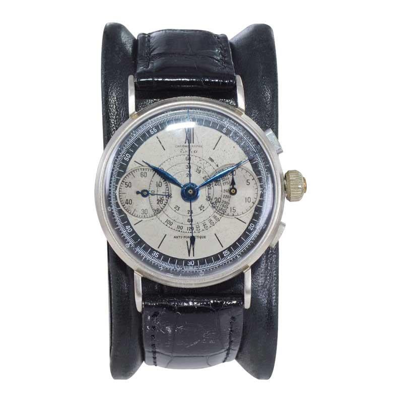 FACTORY / HOUSE: Eska Watch Company
STYLE / REFERENCE: Two Register Three Button Chronograph
METAL / MATERIAL: Nickel Silver
CIRCA / YEAR: Circa 1940's
DIMENSIONS / SIZE: Length 42mm X Diameter 34mm
MOVEMENT / CALIBER: Manual Winding / 17 Jewels