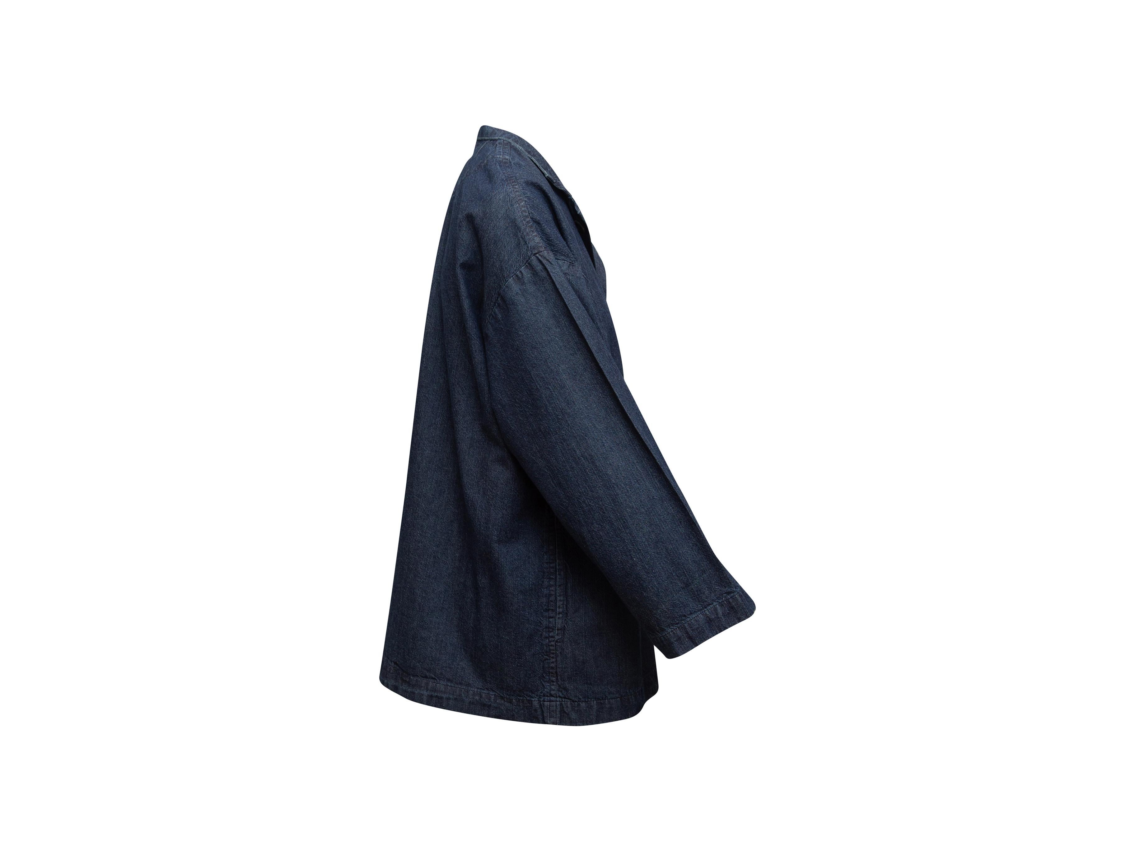Product details: Dark blue denim chore coat by Eskandar. Notched collar. Dual patch pockets. Button closures at center front. 51
