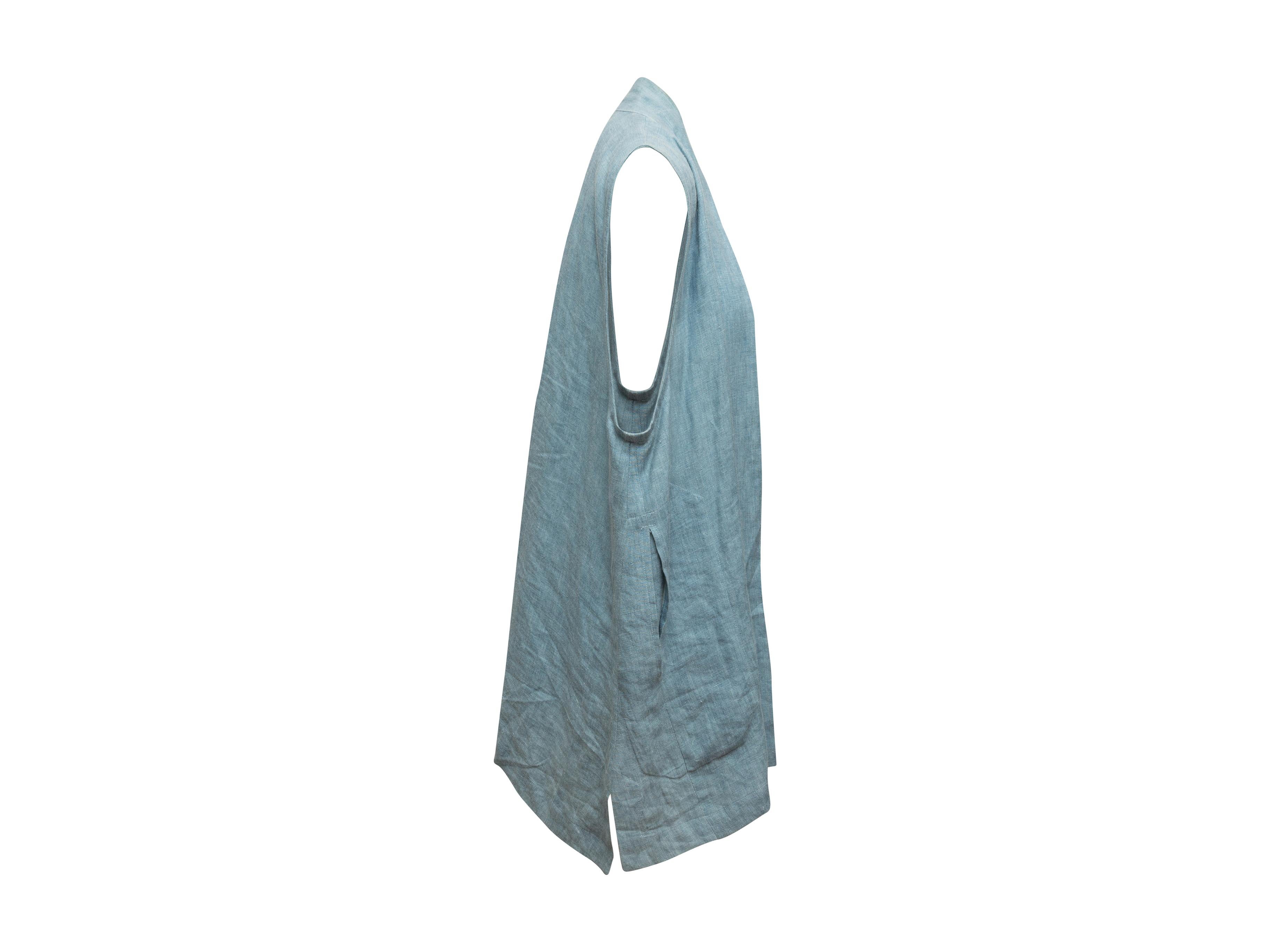 Product details: Light blue linen longline vest by Eskandar. Open front. Dual slit pockets. Slits at sides. 40