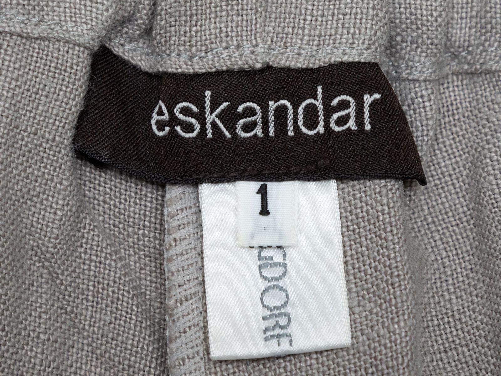Product Details: Taupe wide-leg linen pants by Eskandar. Elasticized waistband at back. Front button closure. Designer size 1. 30