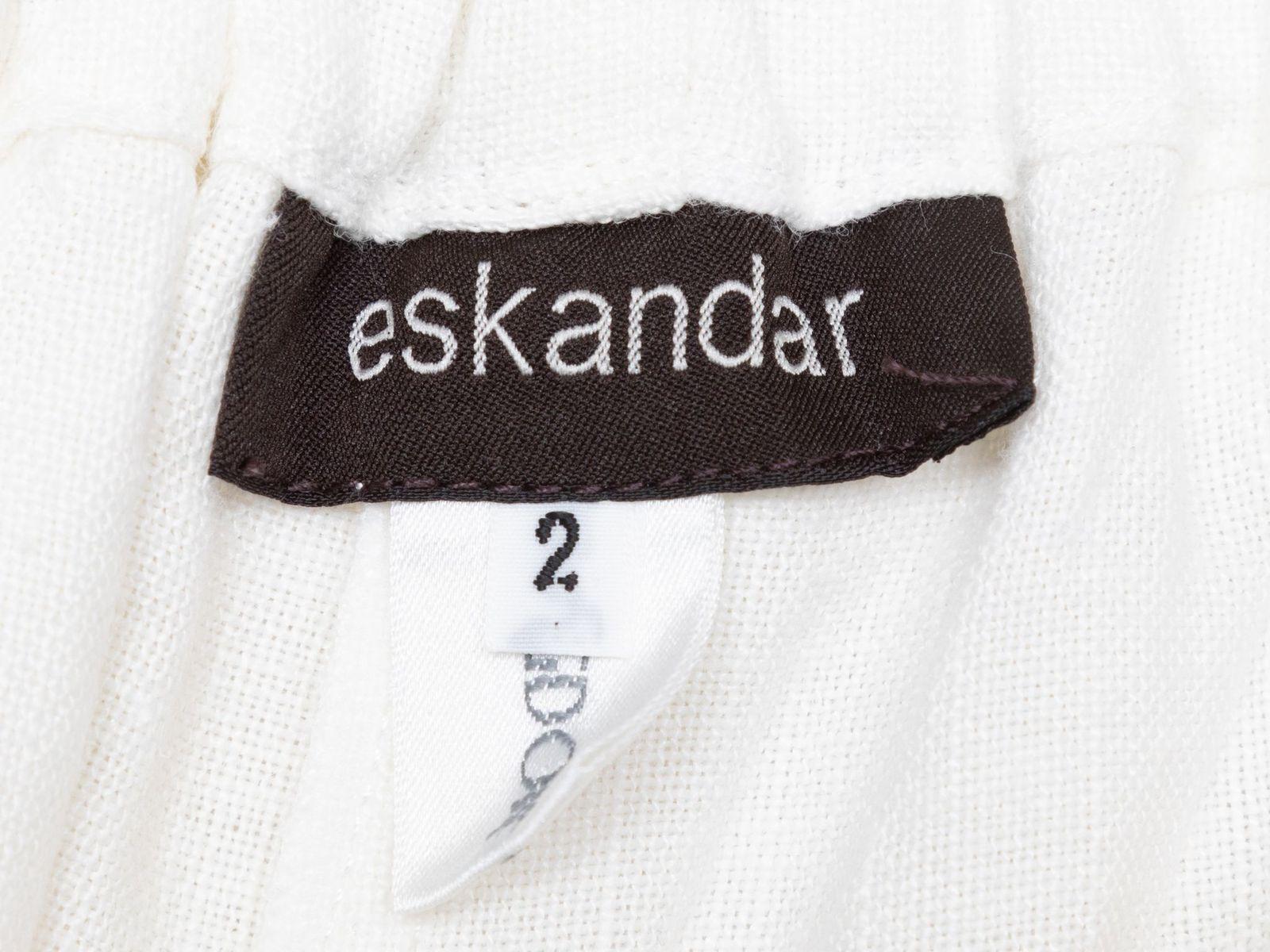 Product Details: White wide-leg linen pants by Eskandar. Elasticized waistband at back. Front button closure. Designer size 2. 30