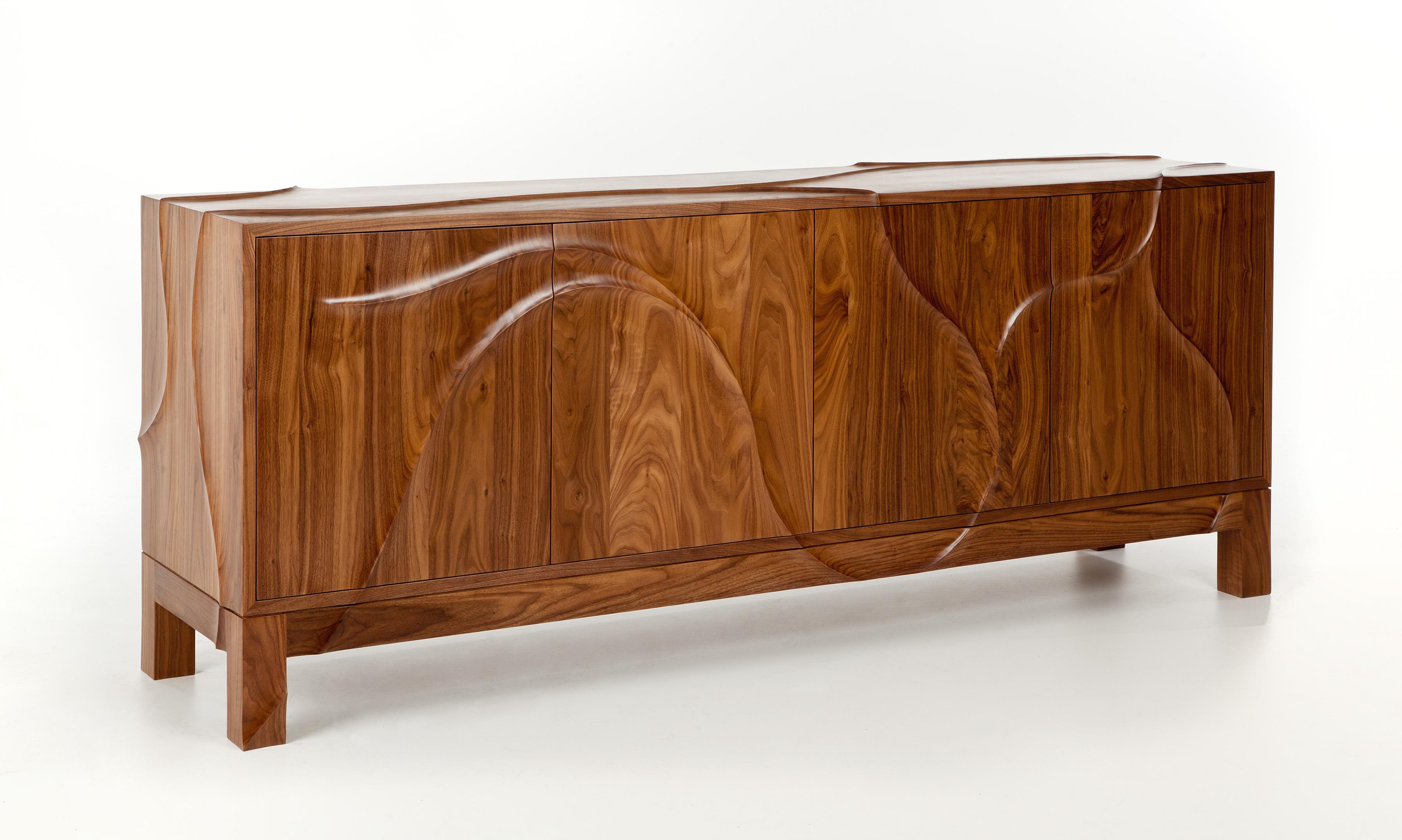Esker Walnut Credenza with hand-carved detailing made to order.

With a distinctive aesthetic that fuses a linear silhouette with an organic flowing pattern and a stunning grain in the finest walnut, this bespoke piece expertly crafted by Dunleavy