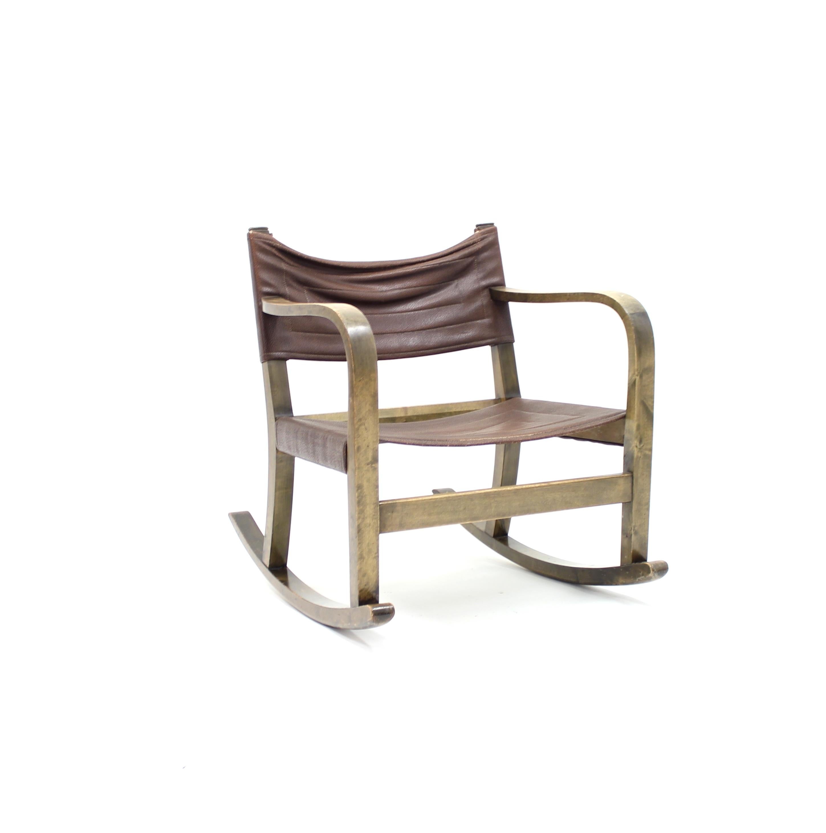 Diminutive Art Deco rocking chair designed by Eskil Sundahl for Swedish manufacturer SMF Bodafors in the 1930s. Frame made of stained birch with original Braun faux leather typ (not real faux leather) on seat and back. Very good untouched original