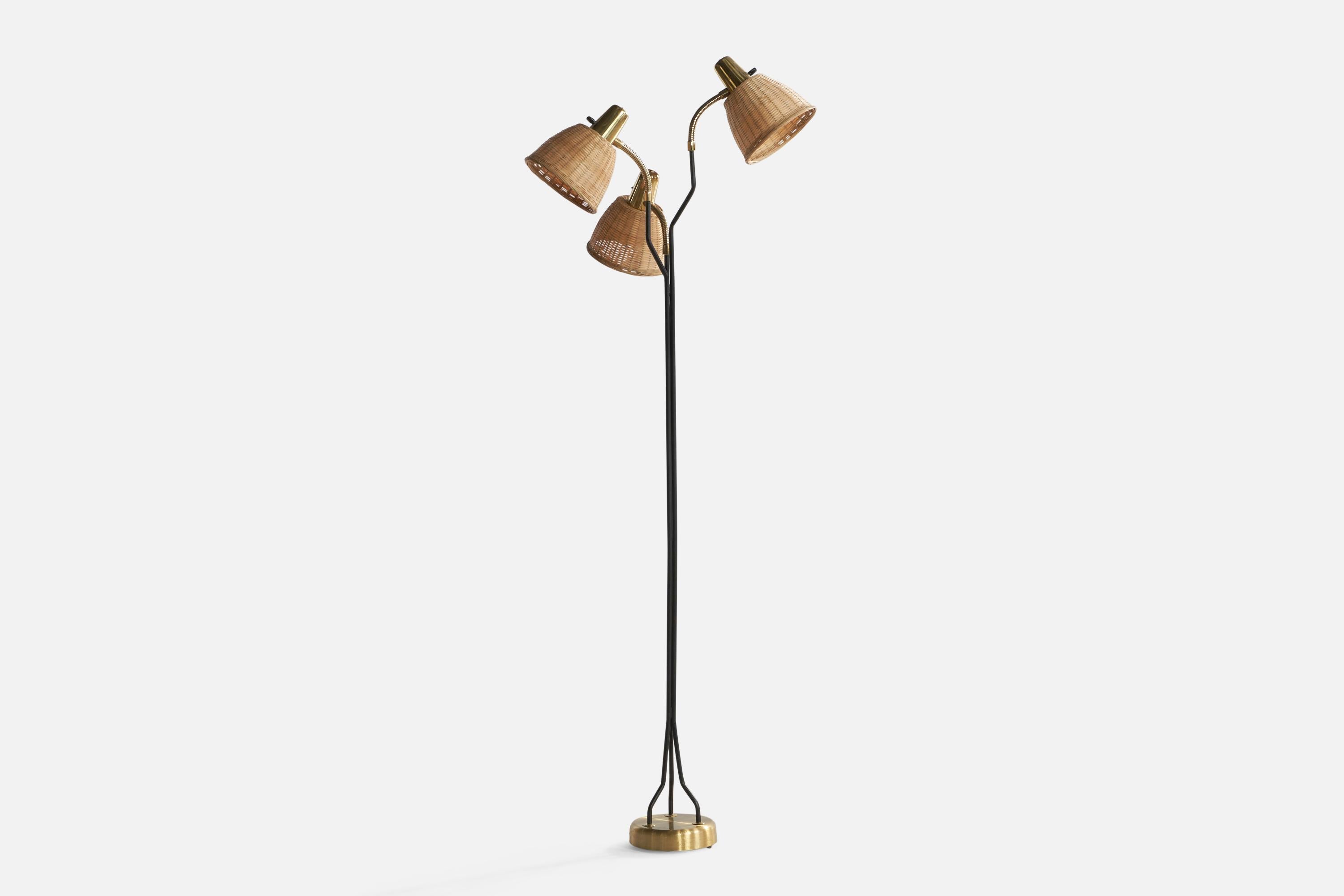 An adjustable three-armed brass, black-lacquered metal and rattan floor lamp, designed and produced by Eskilstuna Elektrofabrik Aktiebolag, Sweden, c. 1960s.

Overall Dimensions (inches): 61.68” H x 20.8” W x 20.8” D. Stated dimensions include