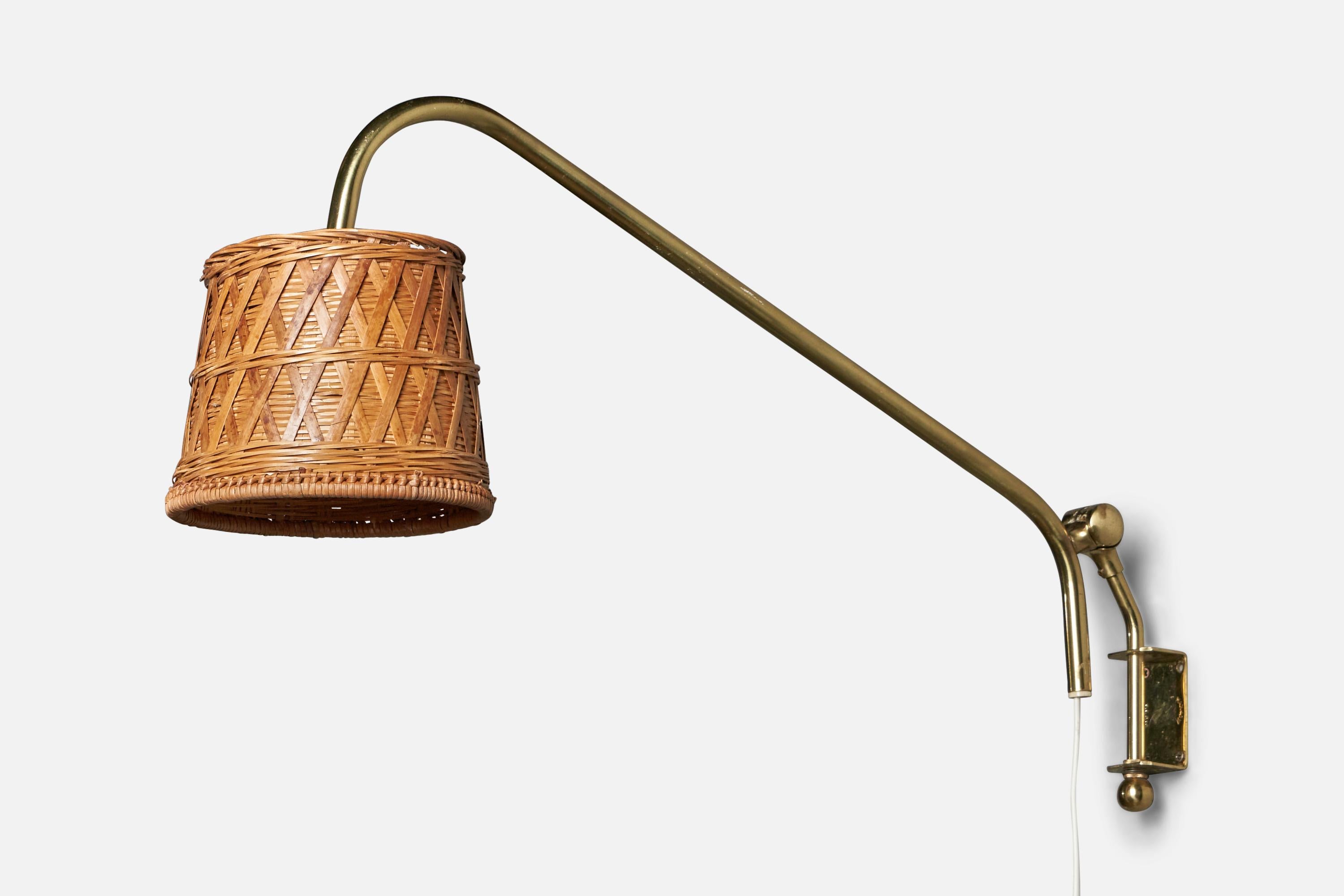 An adjustable brass and rattan wall light designed and produced by Eskilstuna Elektrofabrik, Sweden, c. 1960s.

Overall Dimensions (inches): 11” H x 6” W x 25.5” D
Back Plate Dimensions (inches): 2.5” H x 1.4” W x 1.25” D
Bulb Specifications: E-14