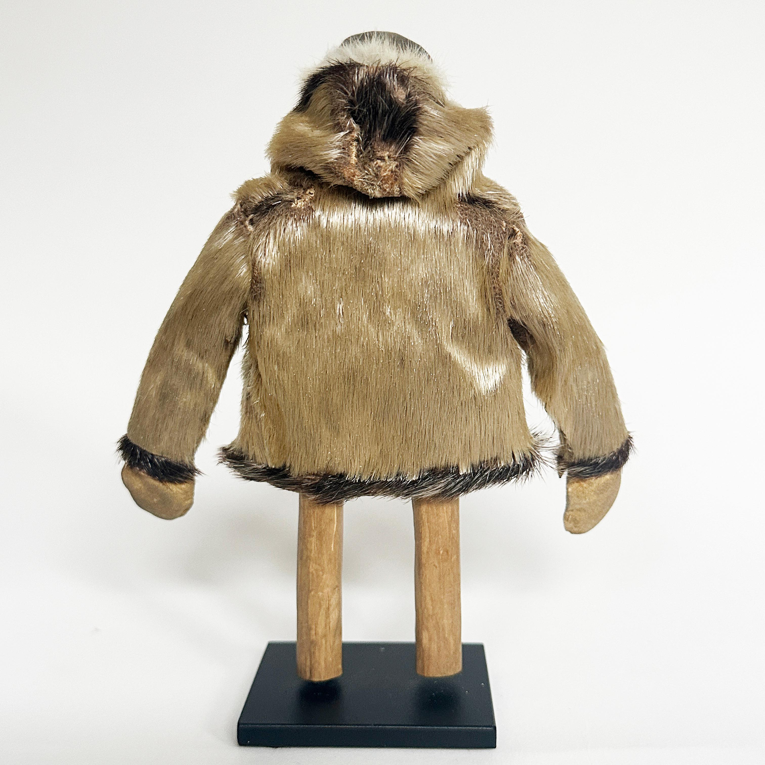Eskimo wood carving of a man with seal coat, North Coast, 20th century

Crude carving of a man dressed in a seal coat. This miniature sculpture is shown standing in a contemporary metal stand, which measures 2.5 x 2 inches. The purpose of this