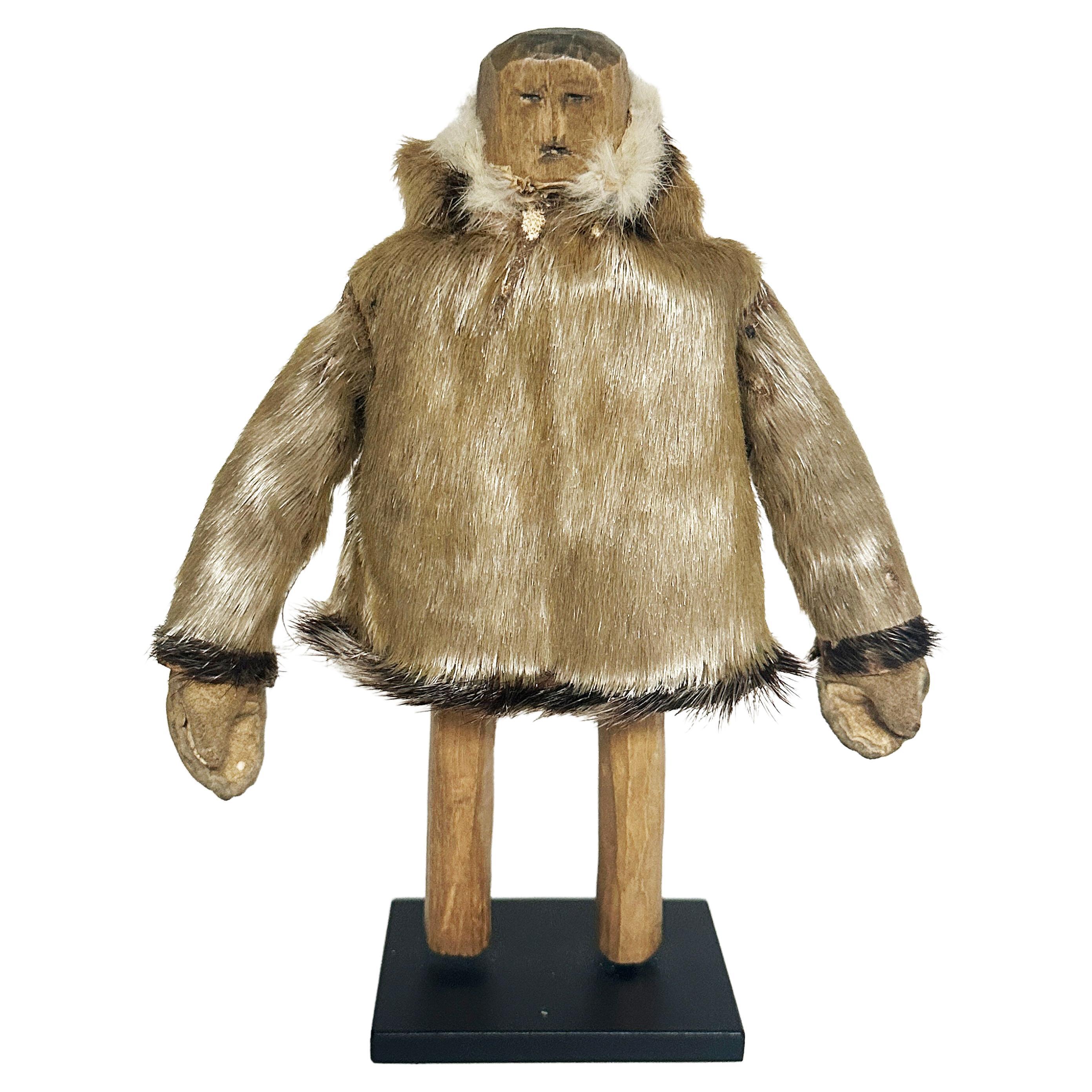 Eskimo Wood Carving of a Man with Seal Coat, North Coast, 20th Century For Sale