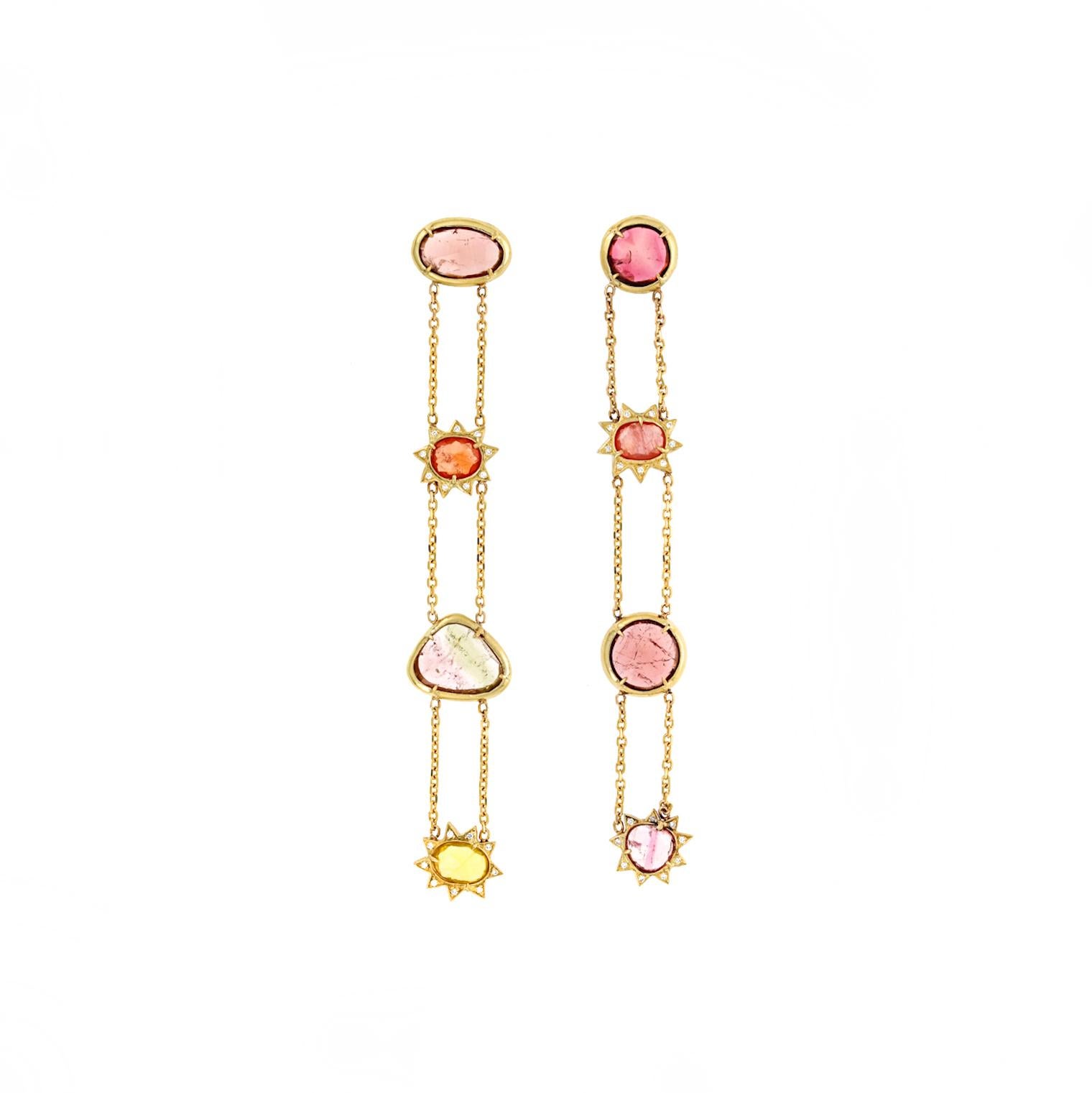 The Esmeralda Earrings are a breathtaking, one-of-a-kind statement piece bursting with vibrant color. Handcrafted in 18kt yellow gold, these 4-inch earrings showcase rose-cut tourmalines and sapphires, accented by sparkling white diamonds. Weighing