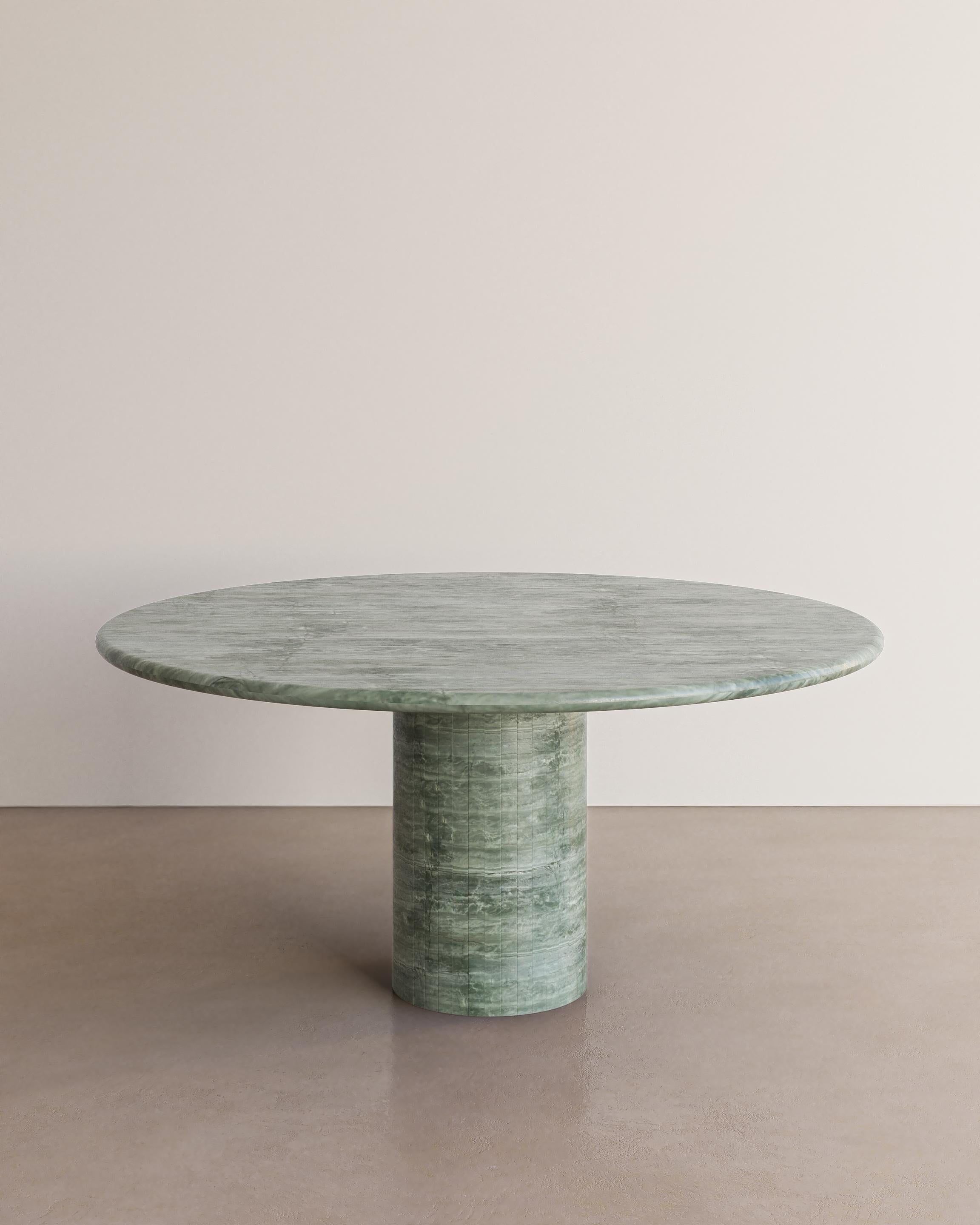 The Voyage Dining Table I in Esmeralda Quartzite sourced in brazil with a polished finish  by The Essentialist celebrates the simple pleasures that define life and replenish the soul through harnessing essential form. Envisioned as an ode to