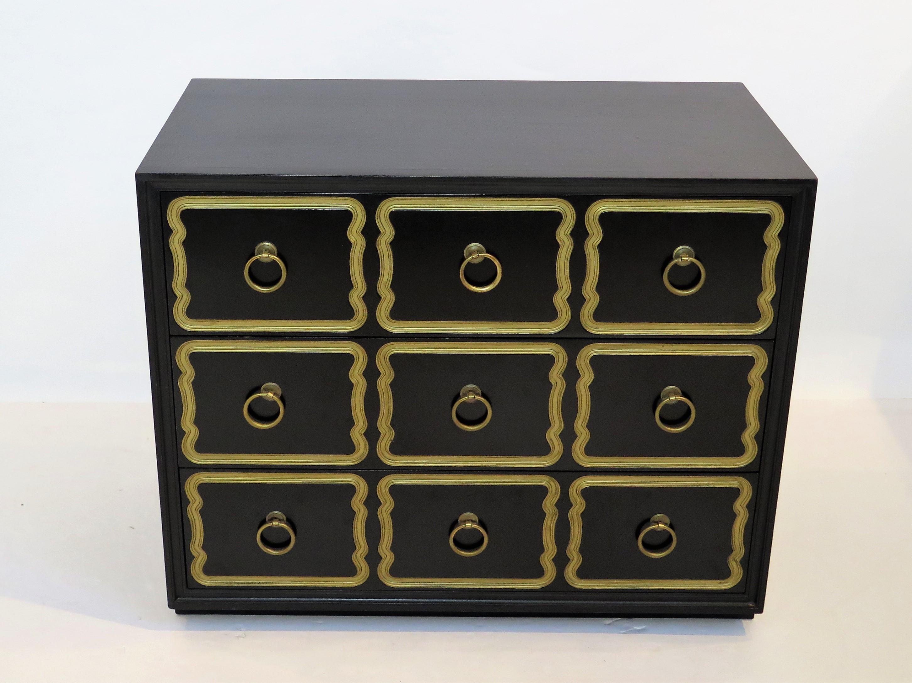 Authentic Espana chest in traditional black bean color designed by Dorothy Draper for Henredon. This Hollywood Regency three drawer chest has incised design and gold accents with original brass pulls. The chest also includes the original top drawer