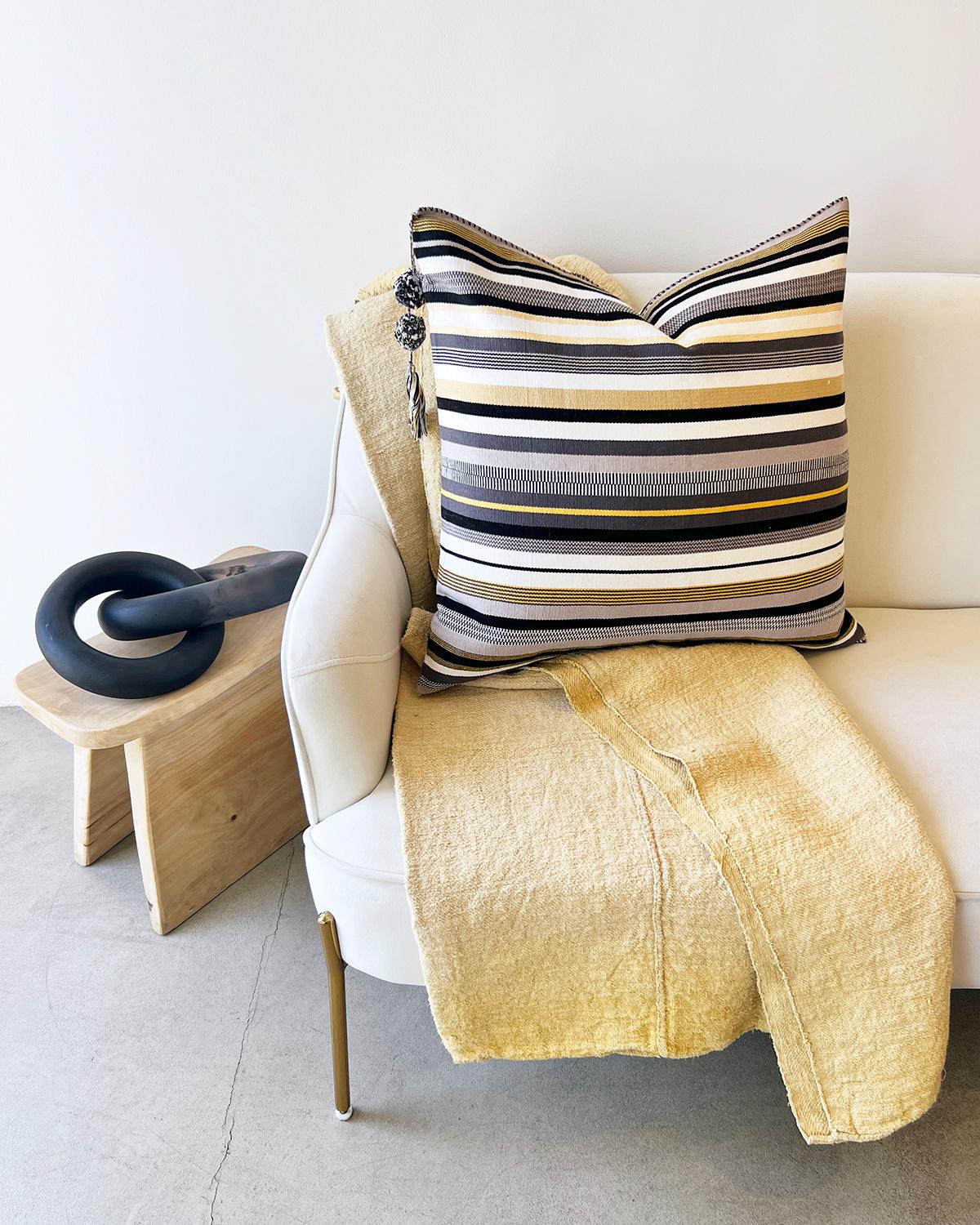 An understated pale yellow throw for your bedroom. This vintage linen throw is hand-painted in a beautiful yellow hue with rustic distressed detail, creating a subtle yet cozy atmosphere. Perfect for the bedroom, this rustic European-inspired throw