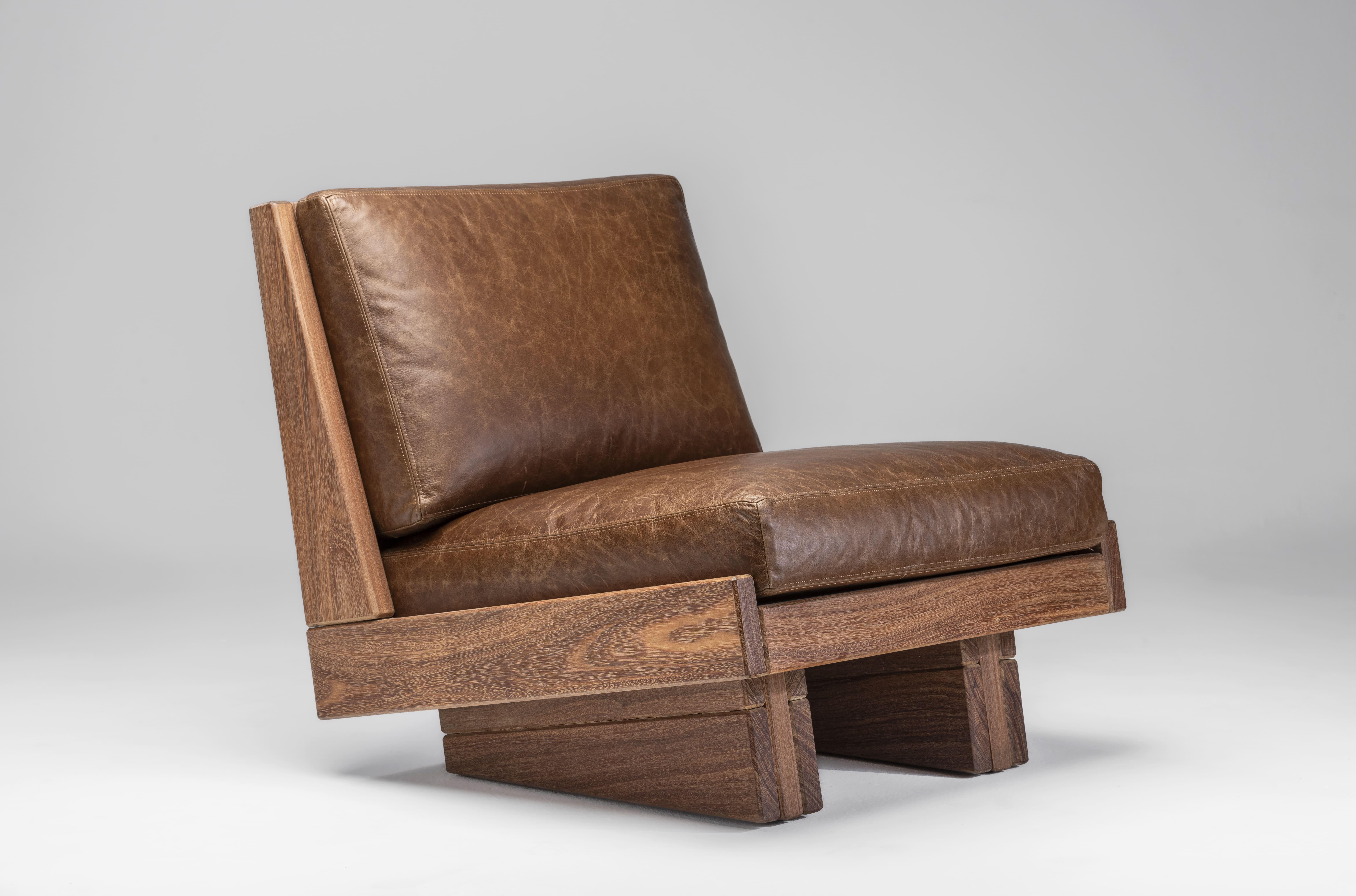 The Espécie Armchair by Zanini de Zanine is crafted from solid Cumaru wood, seamlessly blending modern design with traditional craftsmanship. 
This chair comes in two versions: one with armrests for added comfort and another without, offering a more